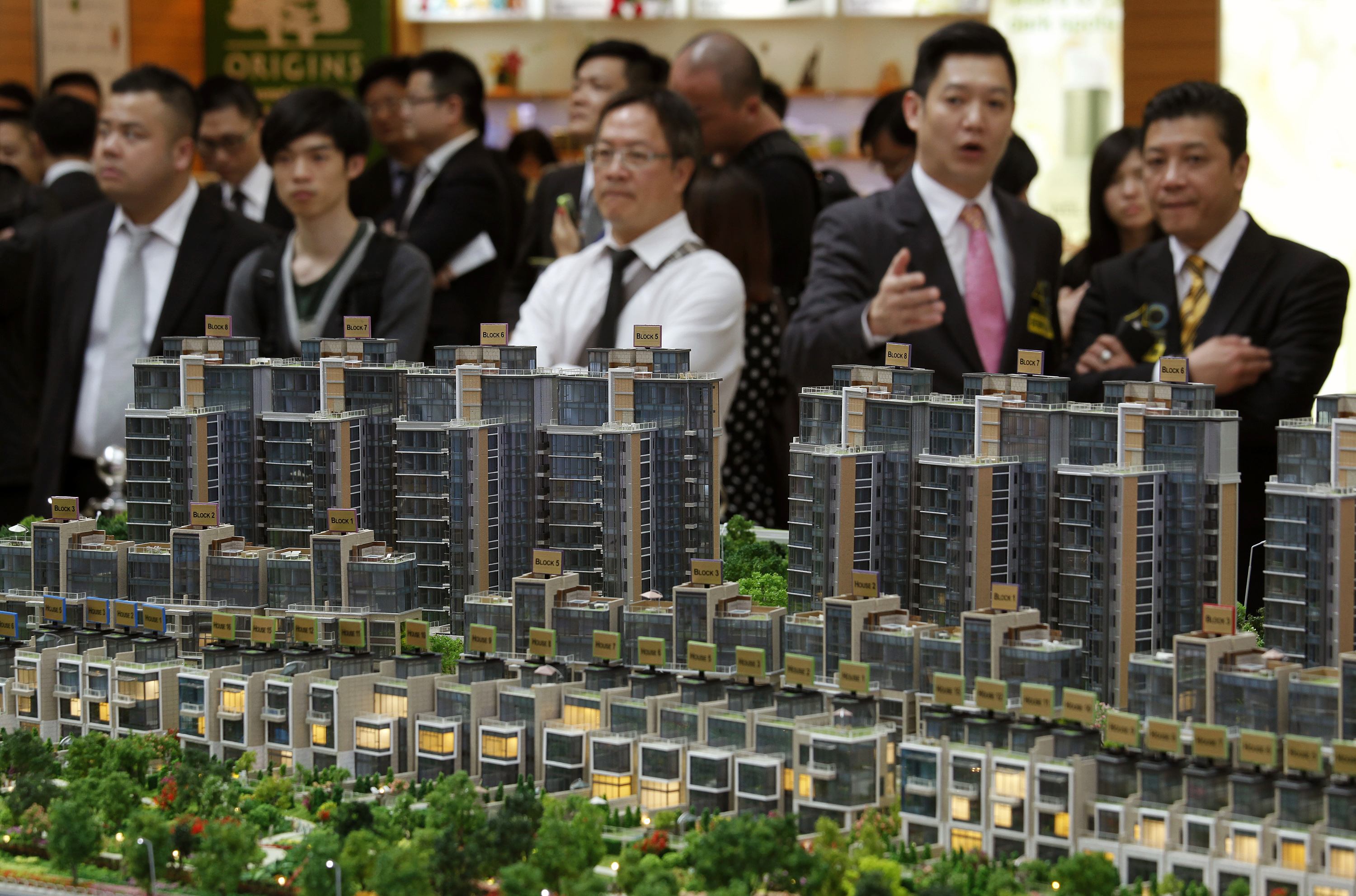 Property sales agents chat during the roadshow of a residential property development in Hong Kong. Photo: Reuters