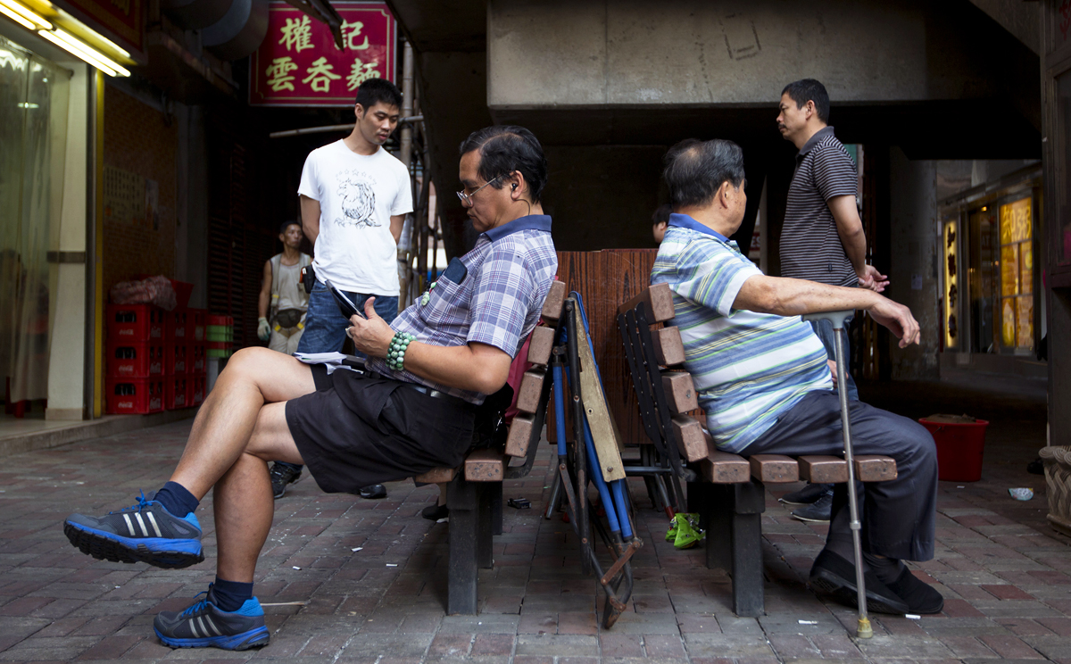 Men sit on a bench in North Point. The fund will be set up this year to cope with structural deficits likely to emerge within a decade amid an ageing population and a shrinking workforce. Photo: Bloomberg