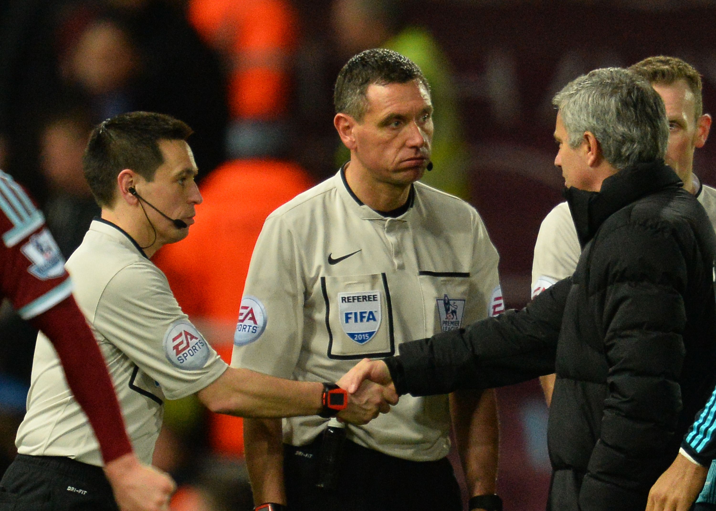 Chelsea's Portuguese manager Jose Mourinho (right) talks to referee Andre Marriner (centre). Disputes with referees over decisions can quickly be resolved if technology is used. Photo: AFP