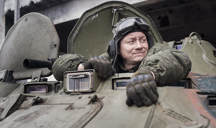 A pro-Russian rebel looks out of a hatch on an APC vehicle outside of a destroyed building at Donetsk International Airport ealier this month. Photo: EPA