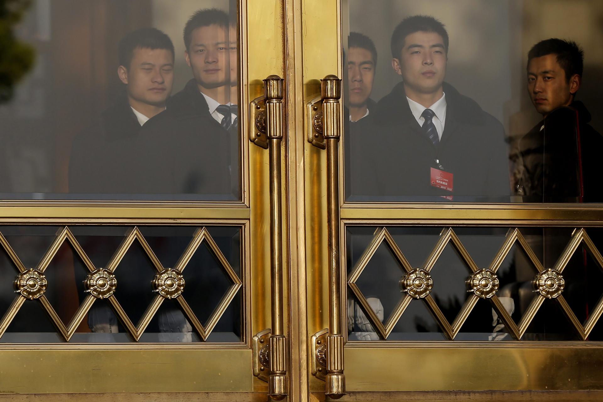 Security officers guard the entrance of the Great Hall of the People during the National People's Congress session in Beijing yesterday. Photo: EPA