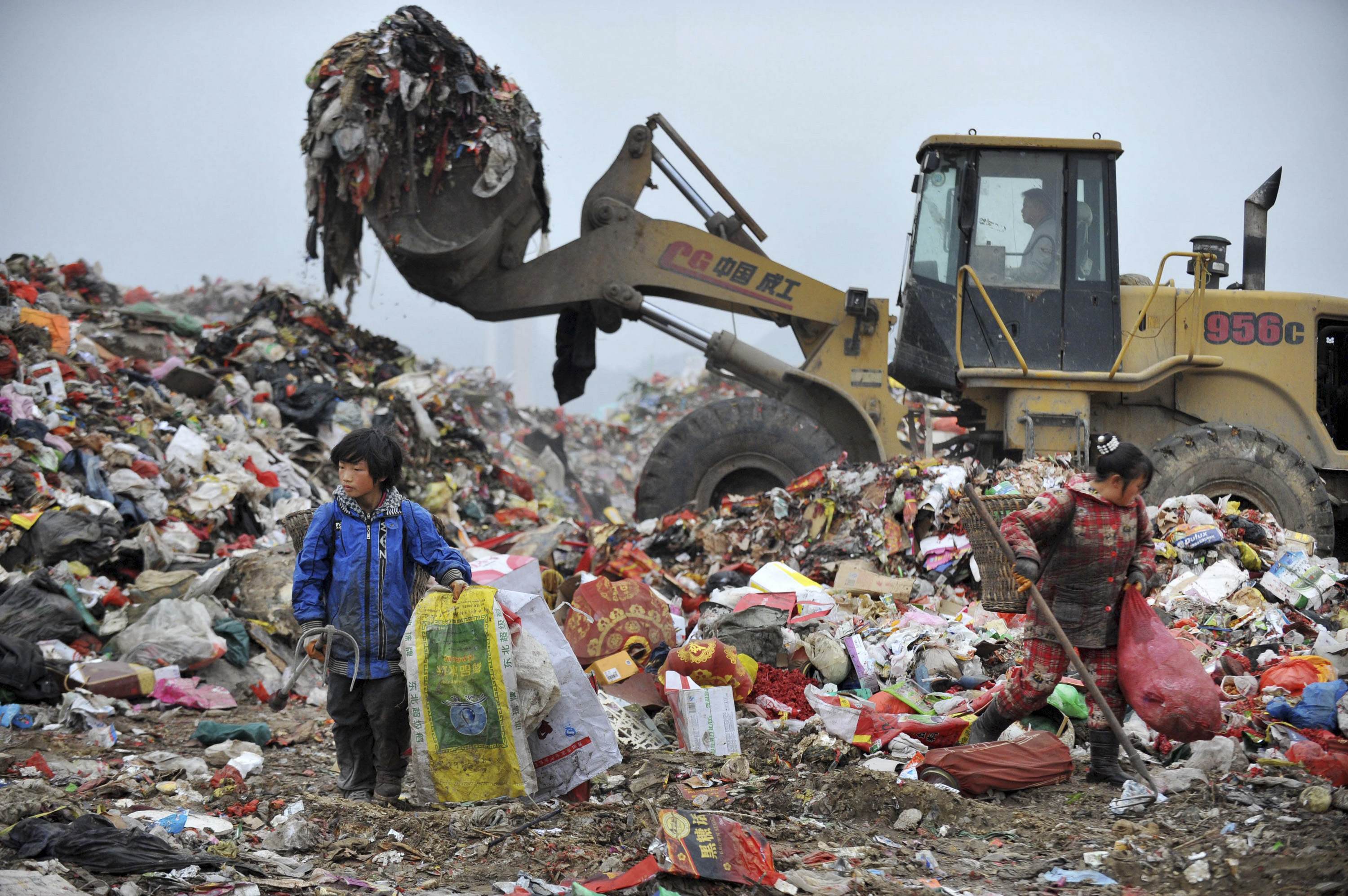 Chinese children sort through rubbish to try to find things they can sell at a dump in Guiyang, Guizhou province. Photo: Reuters