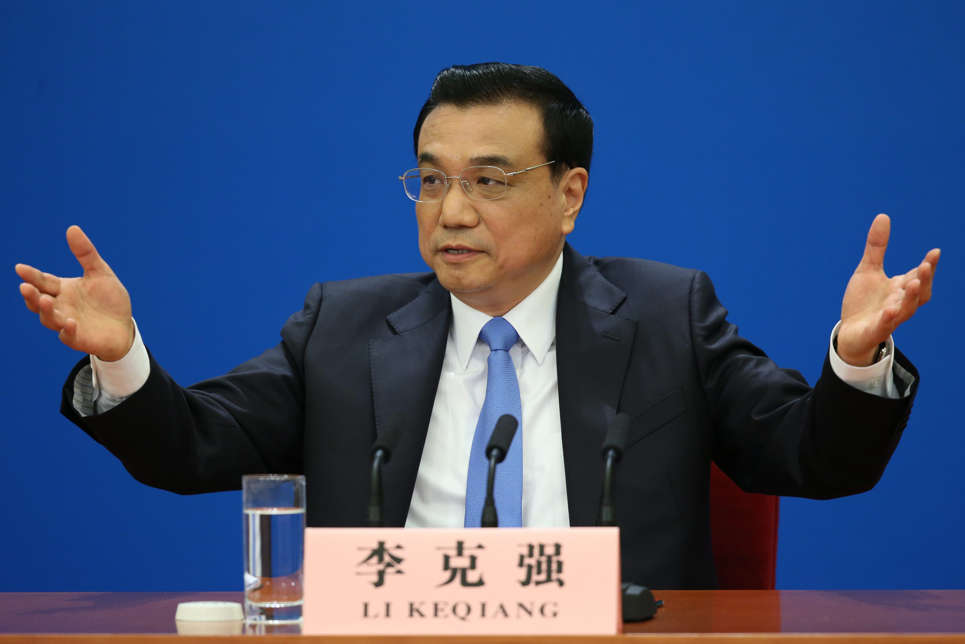 Premier Li answering questions at Sunday morning's press event in Beijing. Photo: EPA