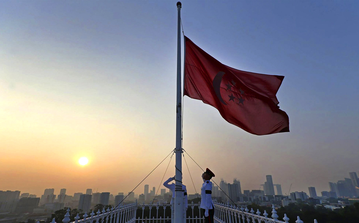 Guards lower the national flag to half-mast at the Istana after the passing of former prime minister Lee Kuan Yew in Singapore. Photo: Lee Hsien Loong's Facebook