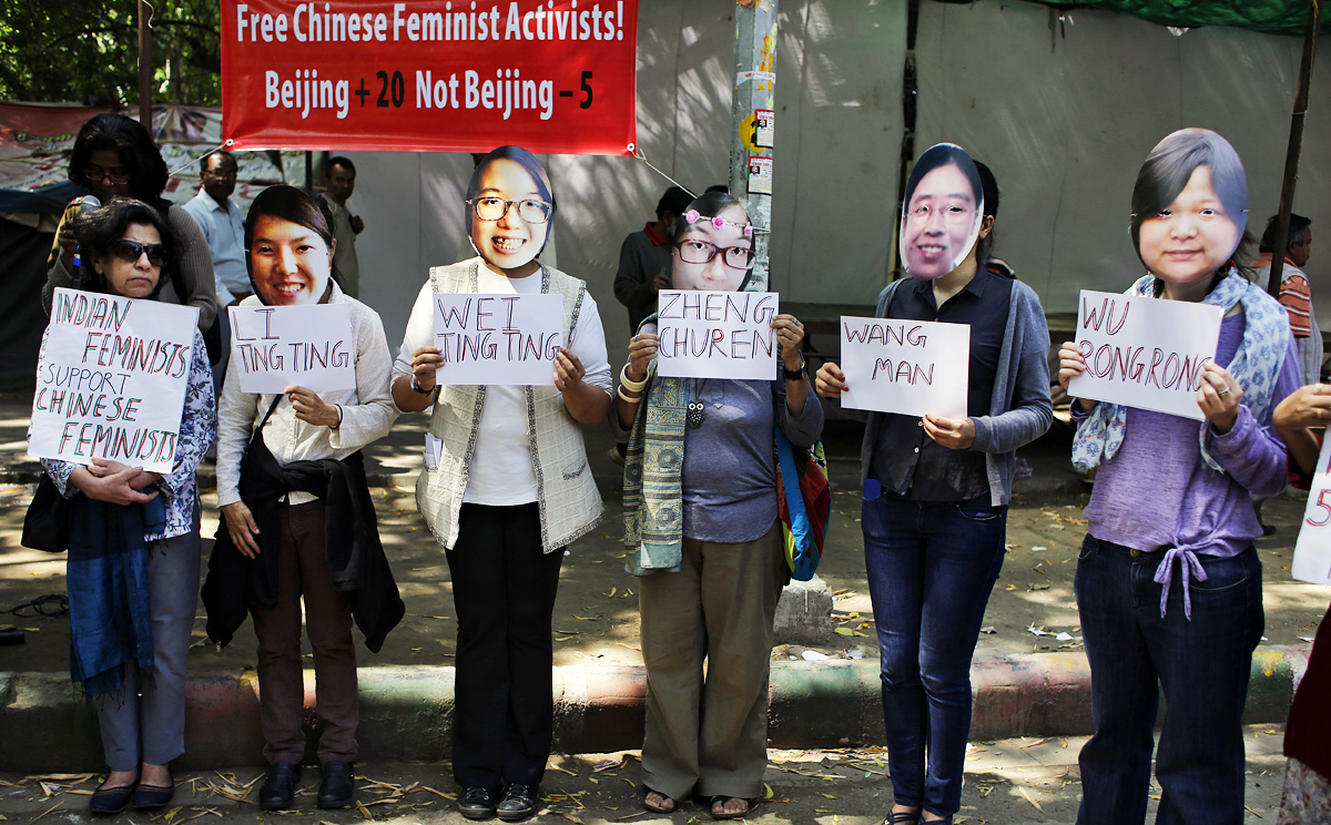 Indian women's rights activists, wearing masks of the five women detained by the Chinese government, demand their immediate release at a New Delhi rally. Photo: AP