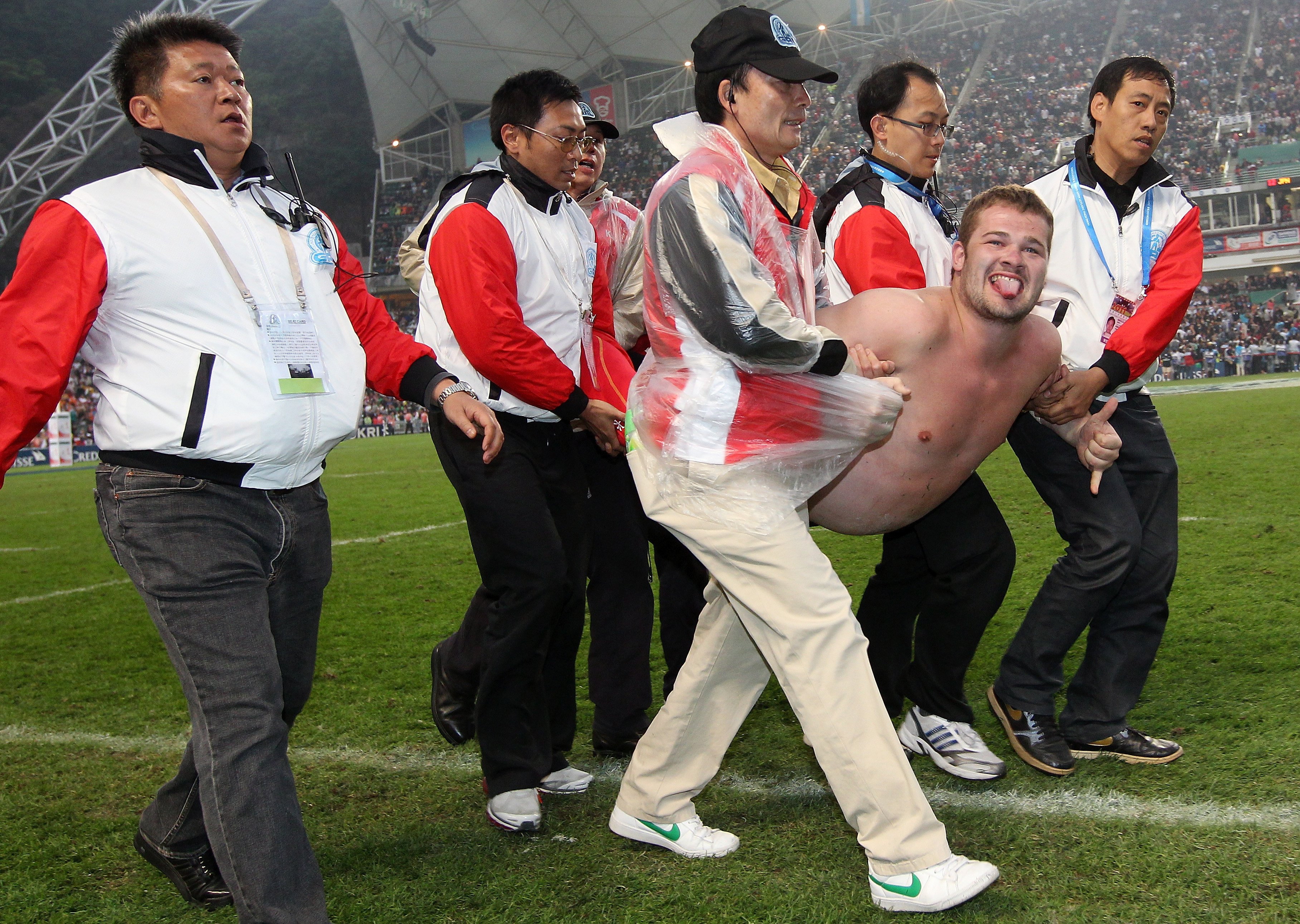 A pitch invader is carried off the field and away to the police station in 2010.