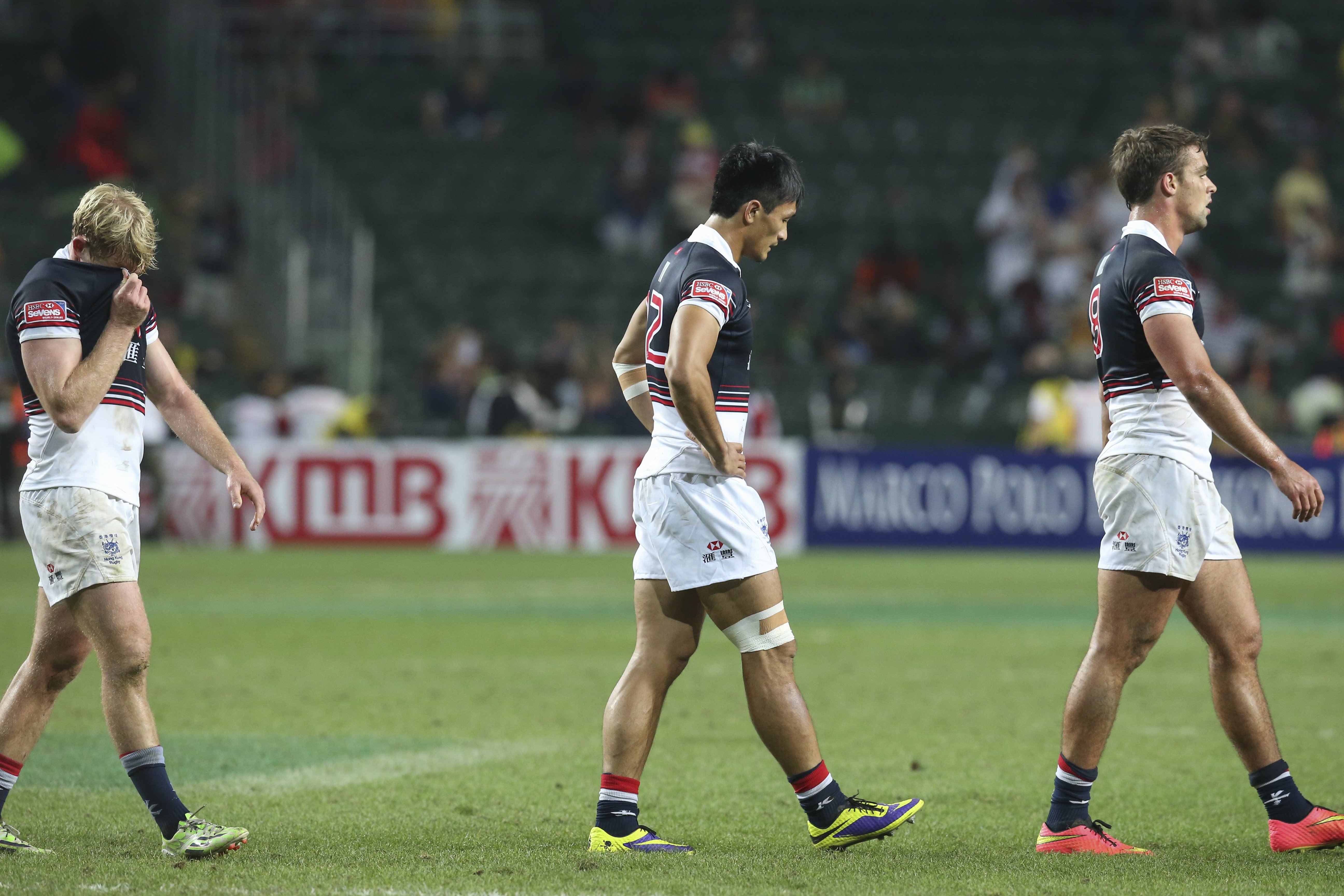 Jamie Hood, Salom Yiu Kam-shing and Chris Maize trudge off after Hong Kong crash out of contention in the battle to win core status on the Sevens World Series. Photo: KY Cheng/SCMP