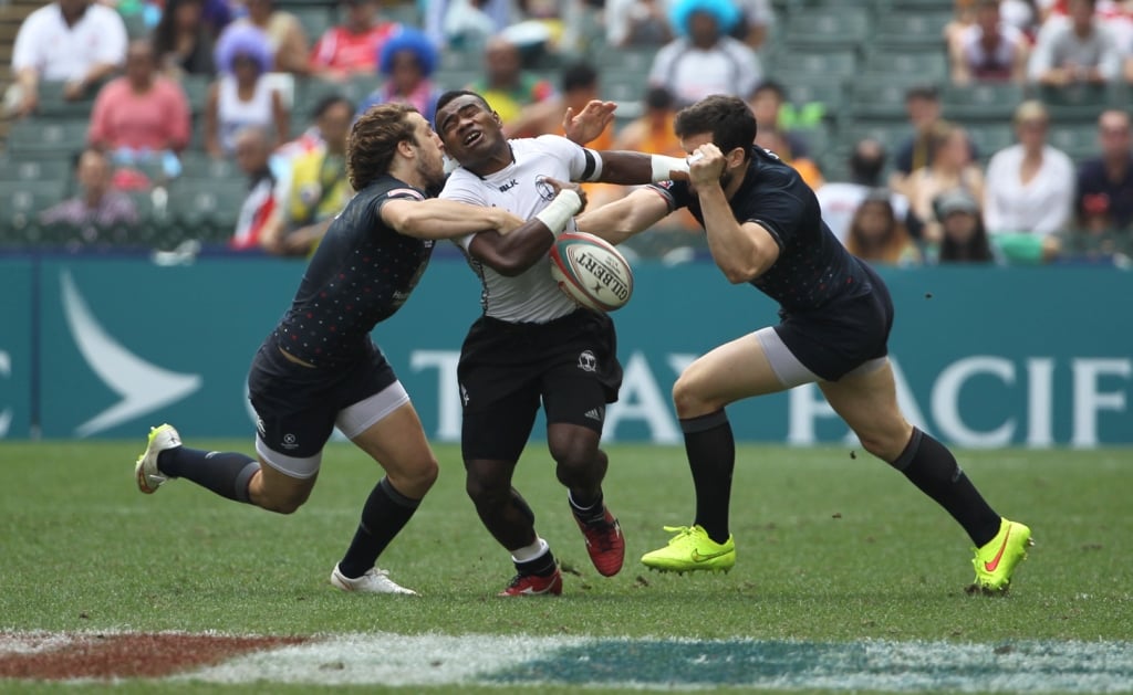 Fiji’s Jerry Tuwai runs into trouble in the Cup quarters against England. Photos: Nora Tam/SCMP