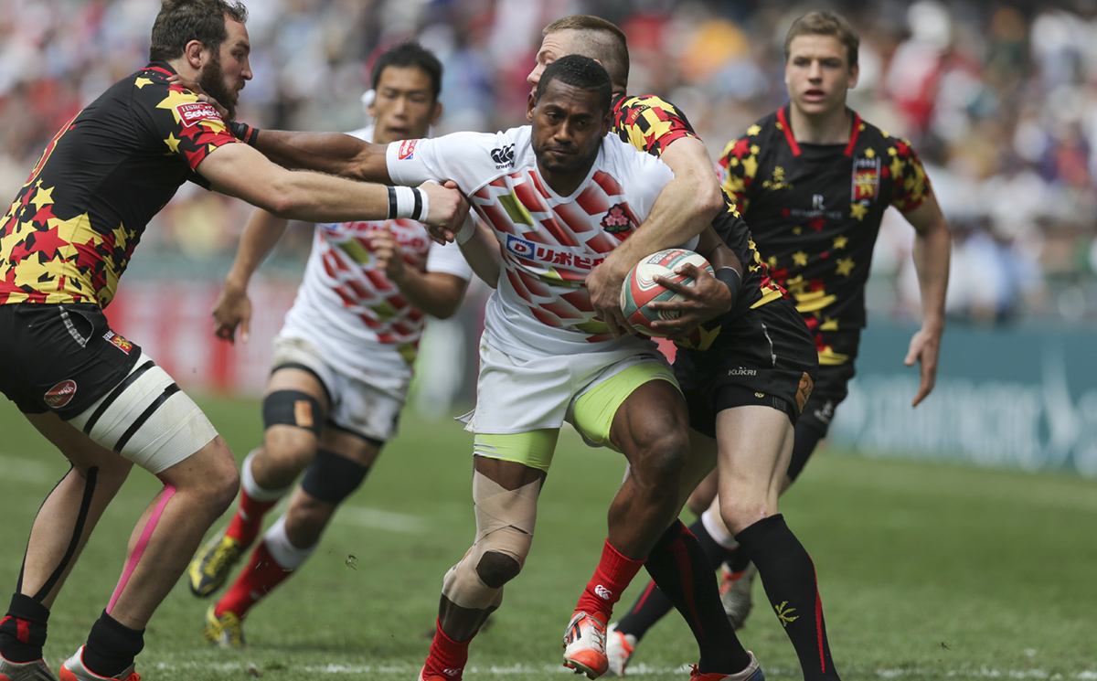 Japan's Lote Tuqiri is tackled by Belgium captain Mathieu Verschelden (left) as he advances during their Shield semi-final on Sunday. Photos: Sam Tsang/SCMP