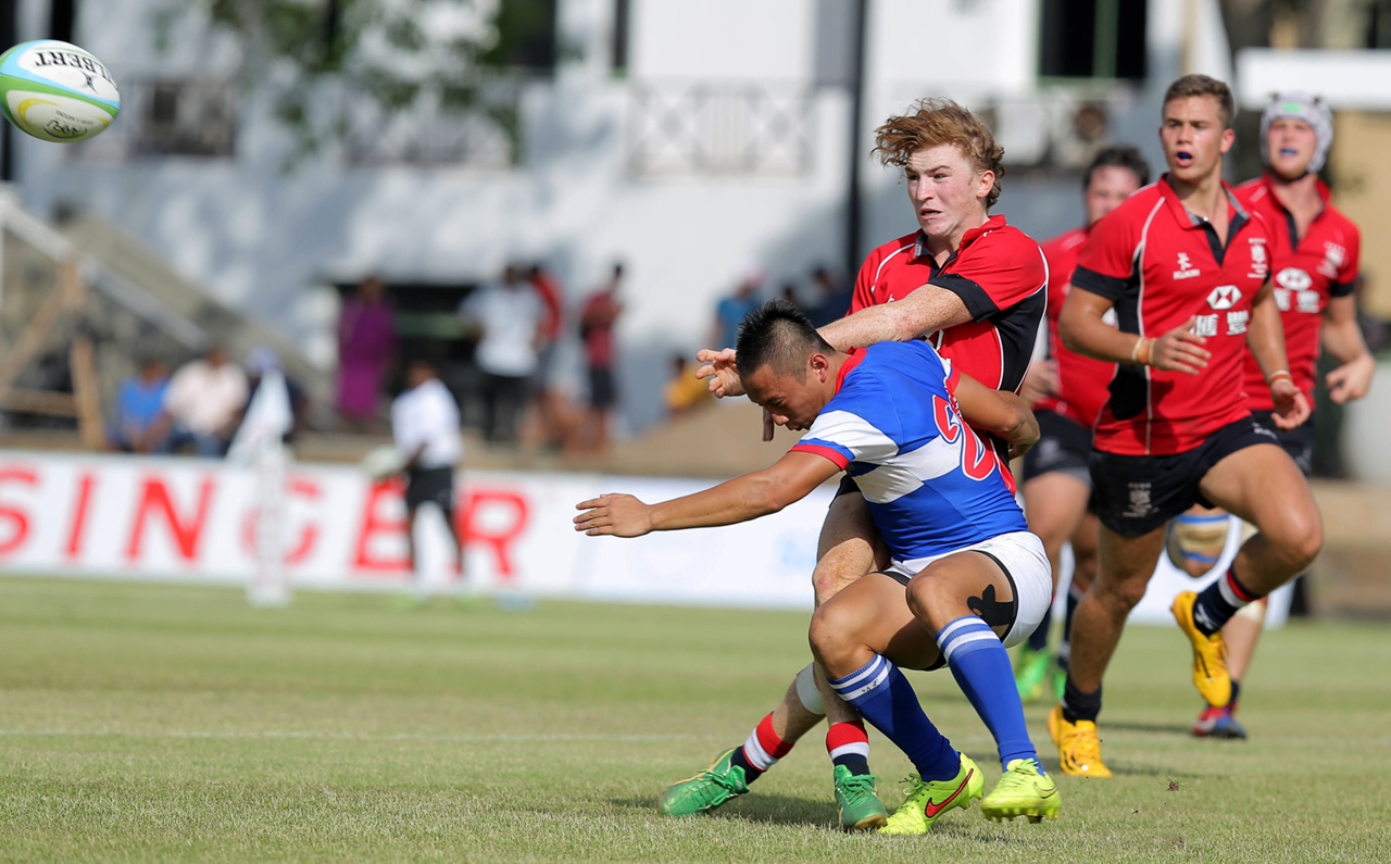 Hugo Stiles gets the ball away under pressure for the Hong Kong U20 fifteens. This weekend in Tokyo, the junior standout will get his first senior sevens cap for Hong Kong at the Japan Sevens. Photo: HKRFU