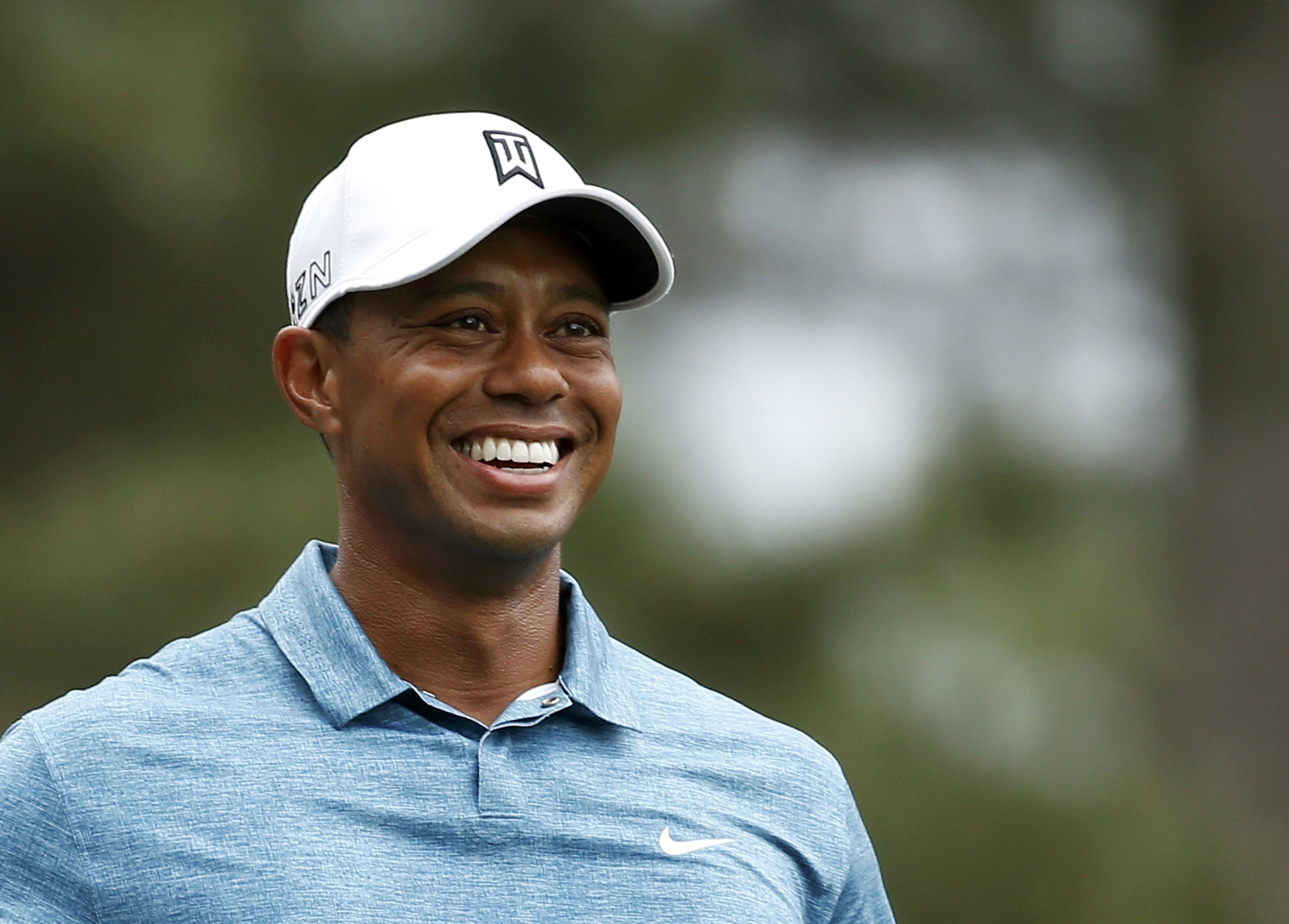 Tiger Woods smiles during his practice round. Photo: Reuters