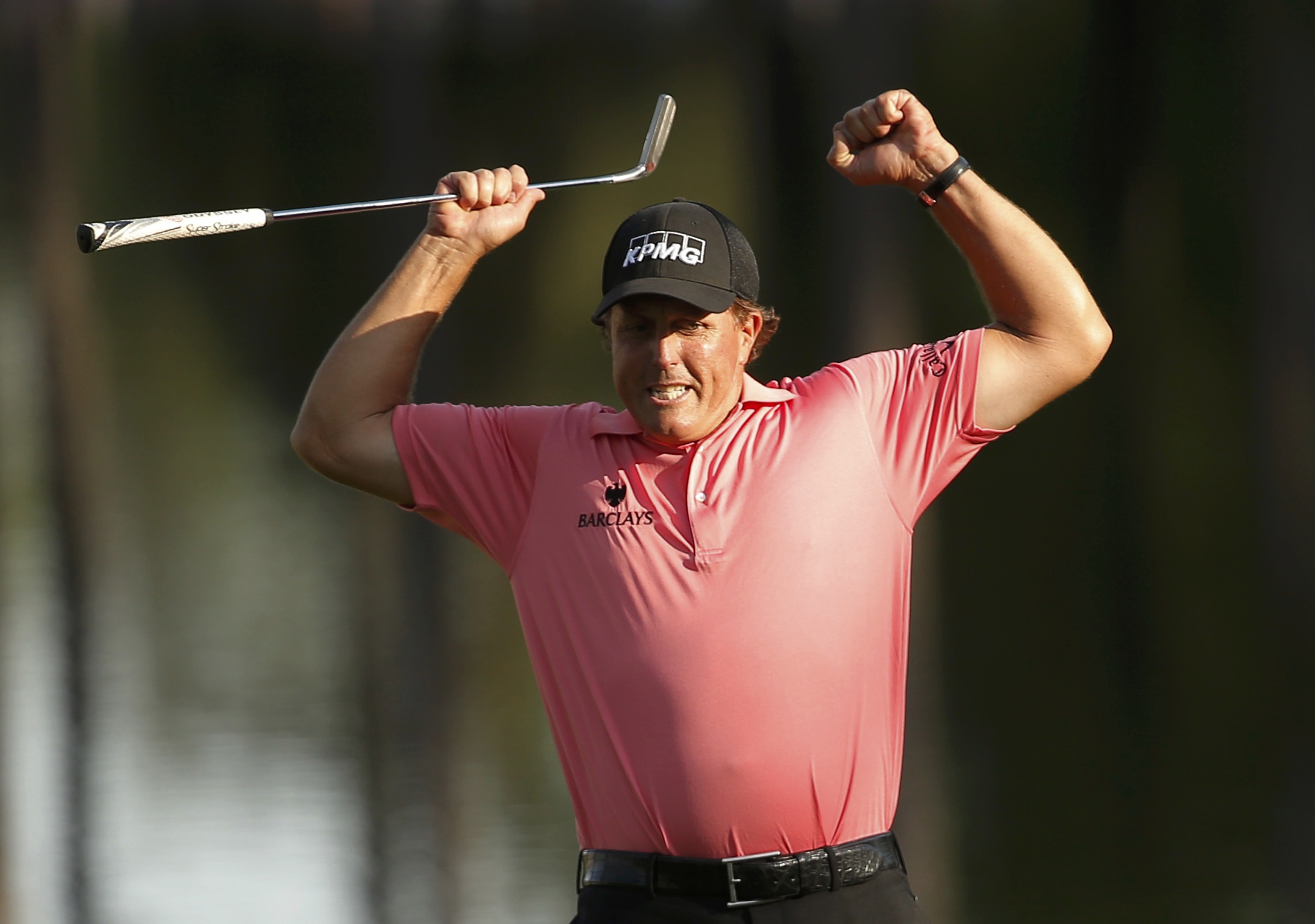 Phil Mickelson celebrates a long birdie putt on 16. Photo: Reuters