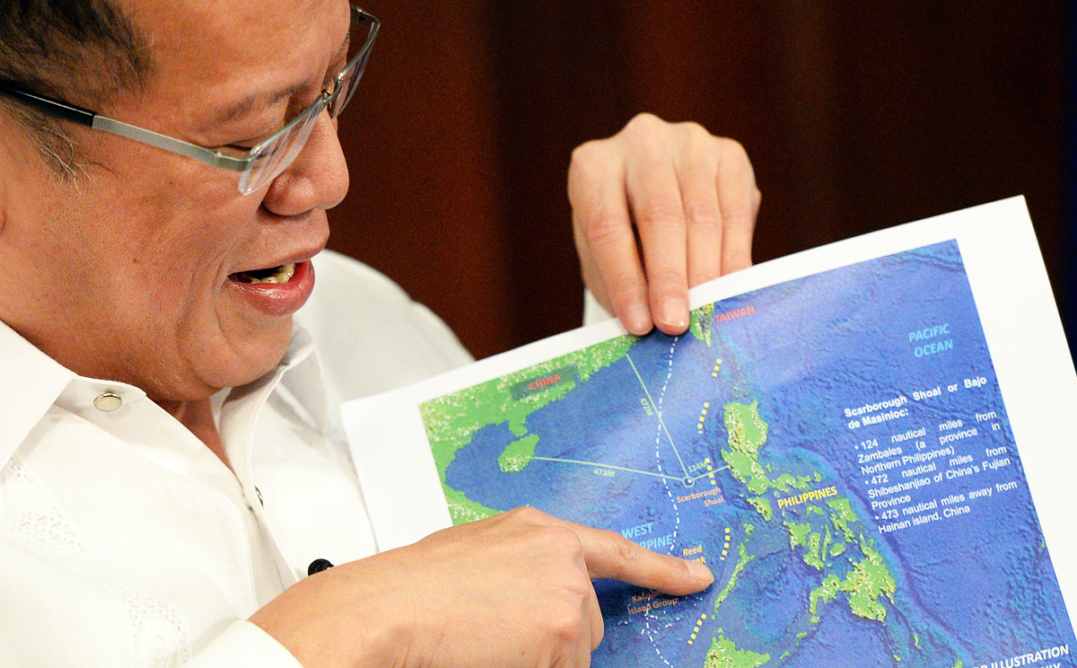 Philippine President Benigno Aquino shows a copy of China's nine-dash line map during an interview at Malacanang Palace in Manila. Photo: AFP