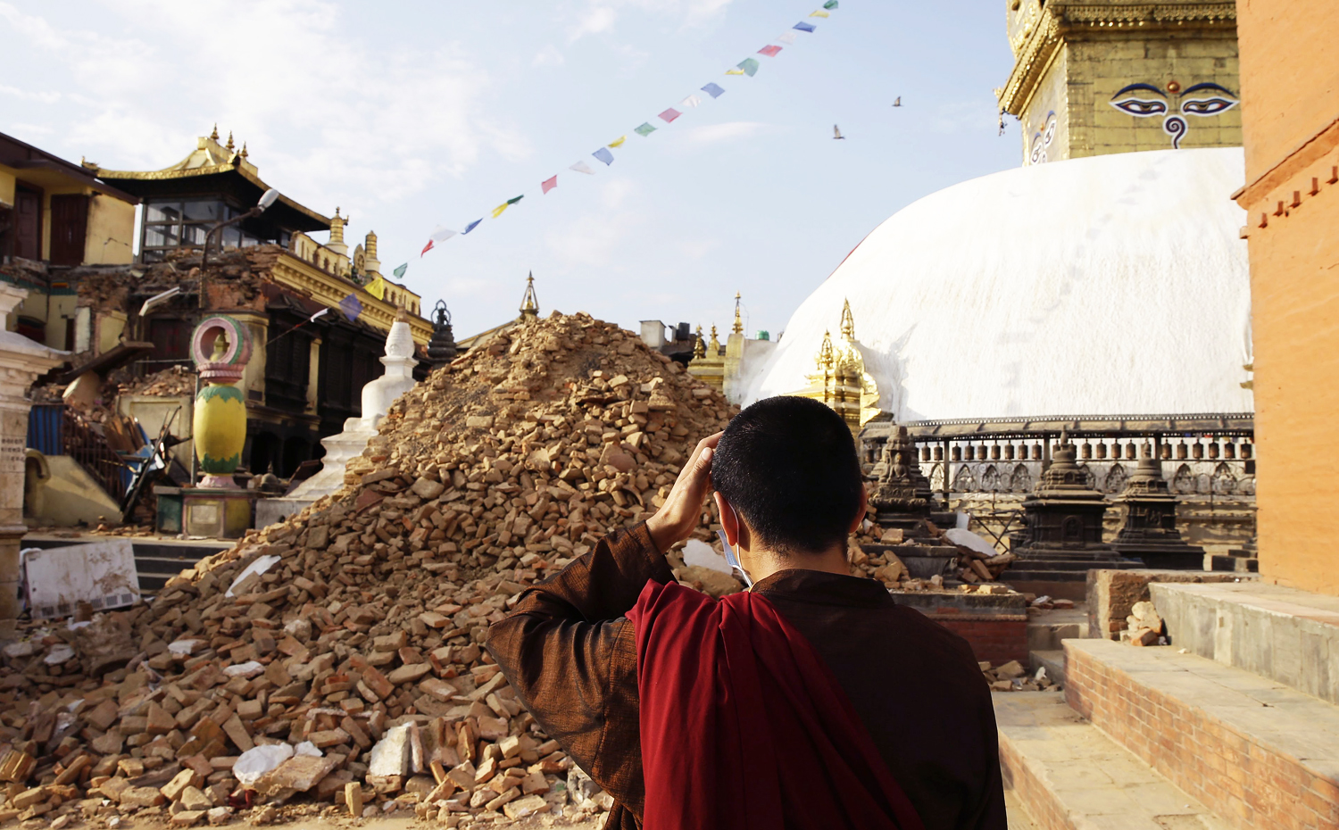 A monk inspects the damage at Nepalese heritage site Syambhunaath Stupa, also known as monkey temple, after a powerful earthquake struck Nepal. Photo: EPA