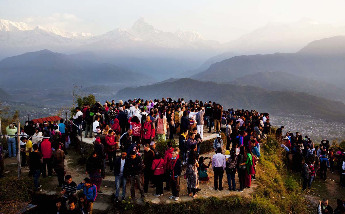 Tourists enjoy the view of Mount Annapurna of the Himalayan Range at Sarangkot in Pokhara, Nepal. Photo: Xinhua