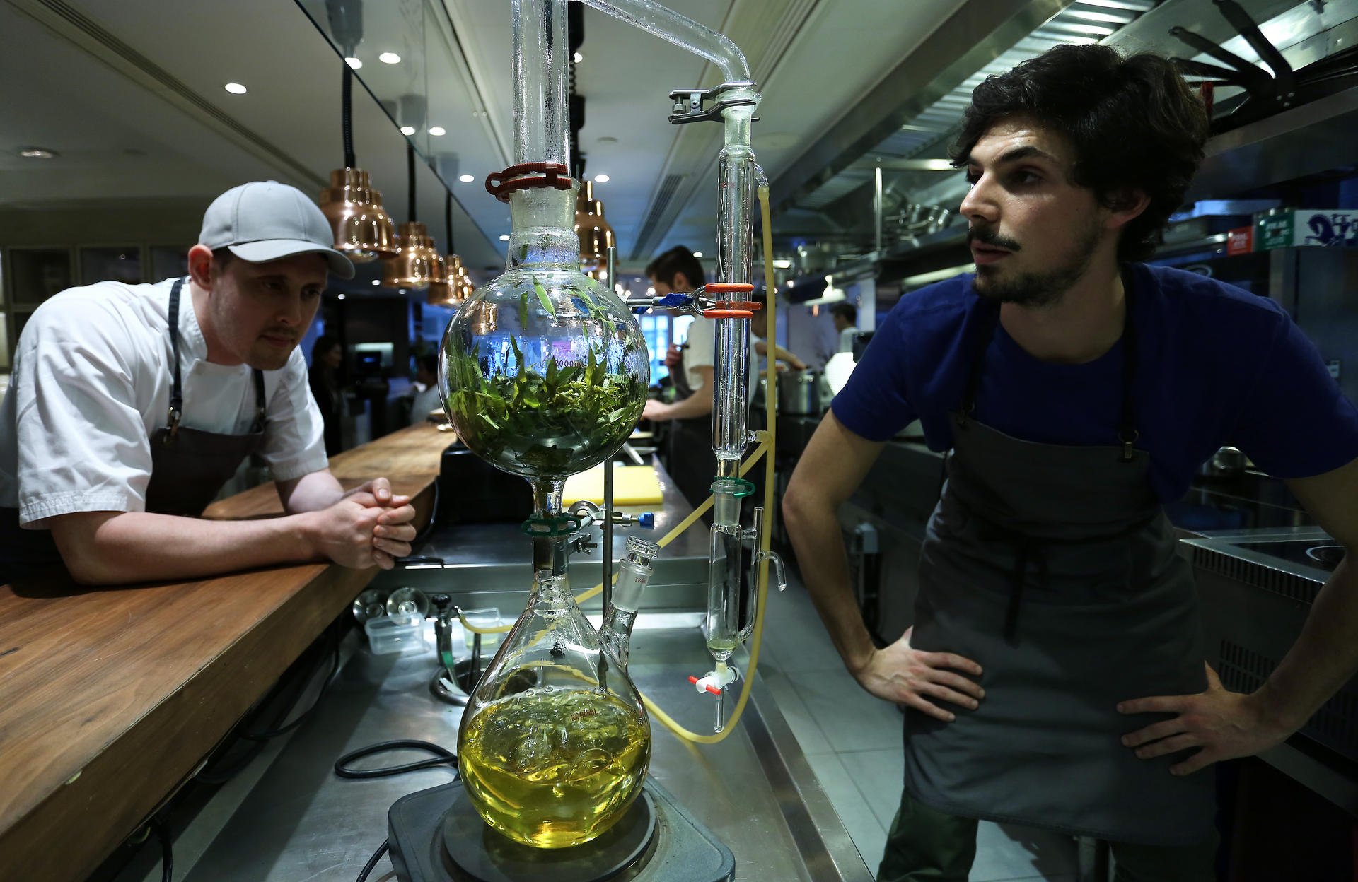 Founder and chef Nurdin Topham (left) and engineer in life sciences and technology Martin Vogel work on their steam distillation equipment for essential oils at NUR restaurant in Central. Photo: Jonathan Wong