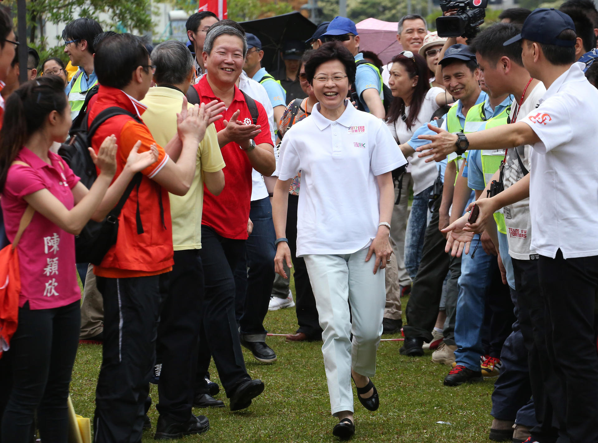 Chief Secretary Carrie Lam receives a warm welcome at the Federation of Trade Unions' Labour Day rally at Tamar Park. Photo: Felix Wong