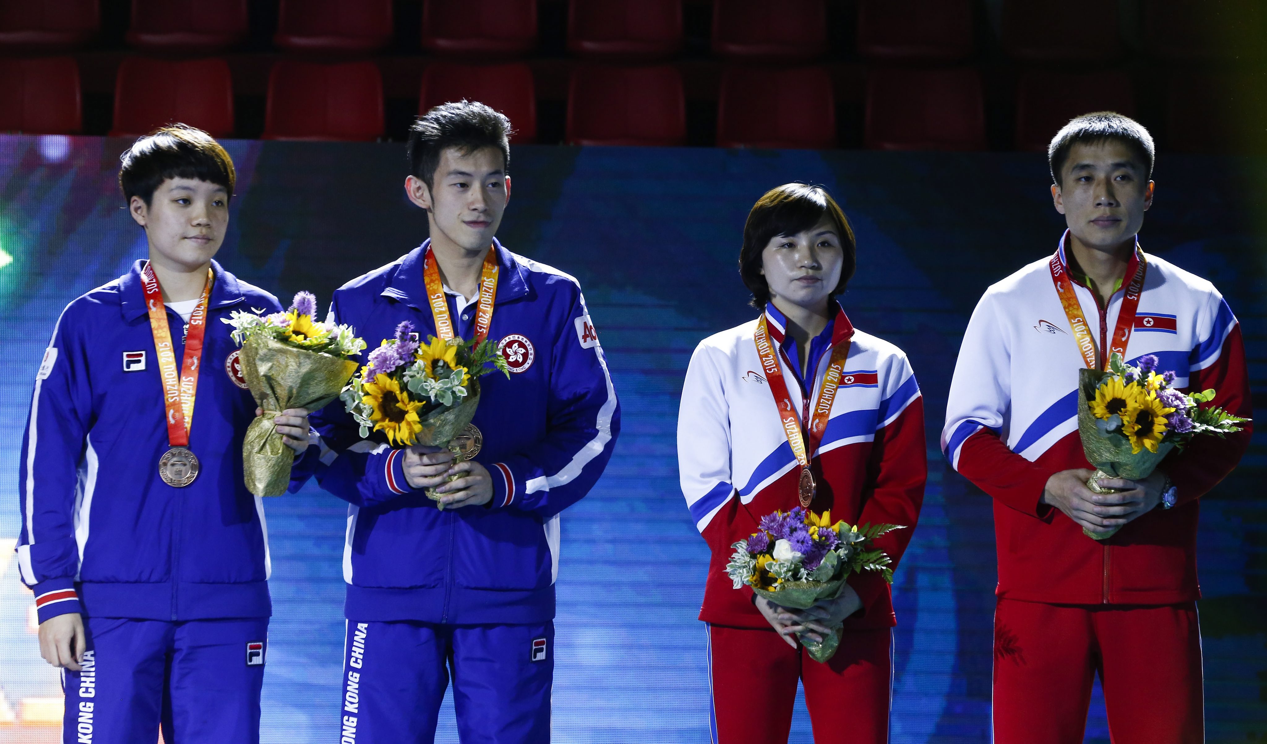 Doo Hoi-kem  (left) and Wong Chun-ting of Hong Kong, along with Koreans Kim Jong and Kim Hyok-bong, receive their mixed doubles bronze medals at the World Table Tennis Championships in Suzhou. Photo: EPA