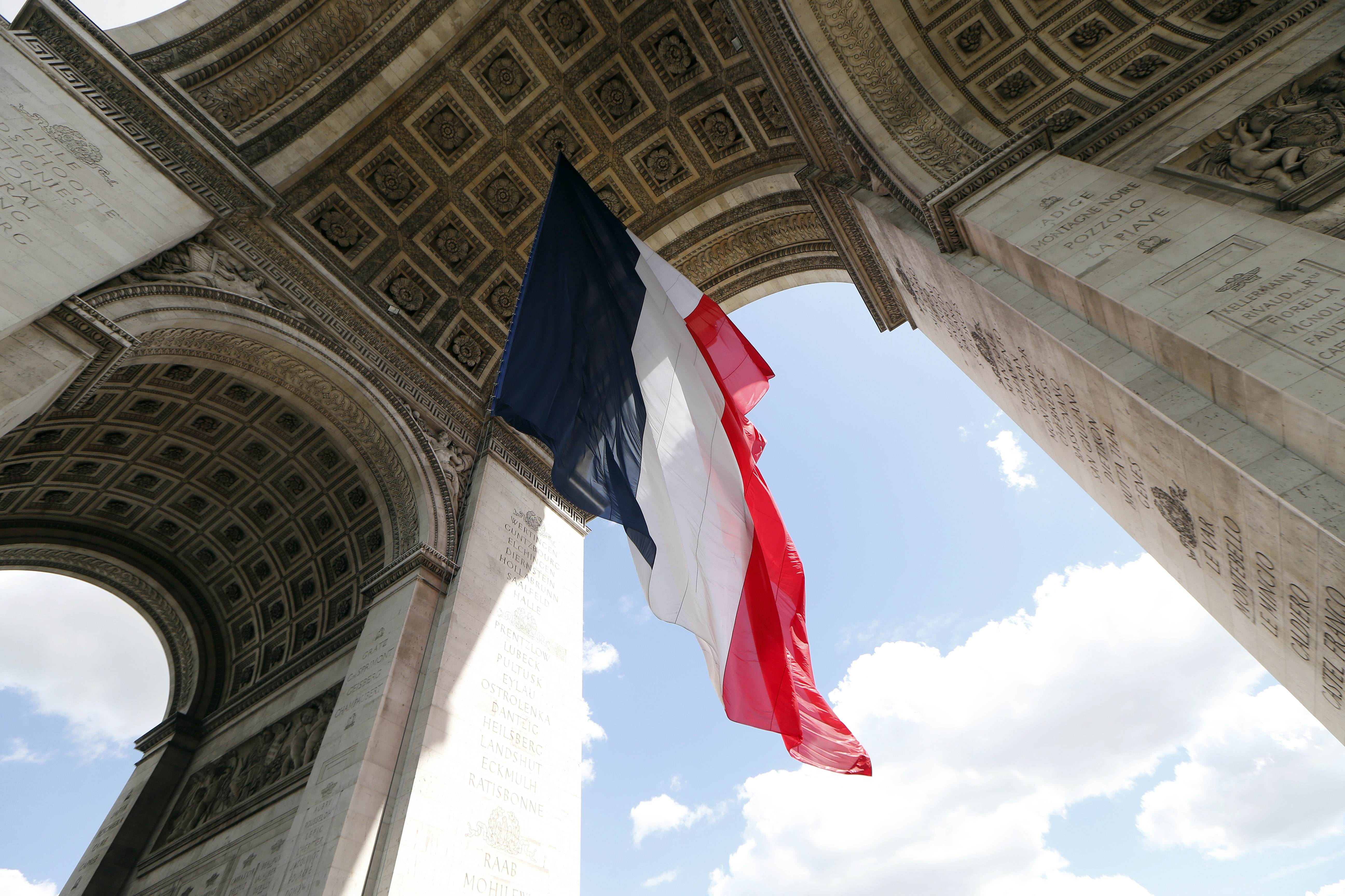 A French flag hangs under the Arc de Triomphe monument in Paris in preparation for Europe Day celebrations. Photo: AFP