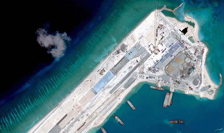 A handout photo taken on April 2 by satellite image provider DigitalGlobe shows what is claimed to be an airstrip at Fiery Cross Reef in the Spratly Islands under construction by China. Photo: AFP