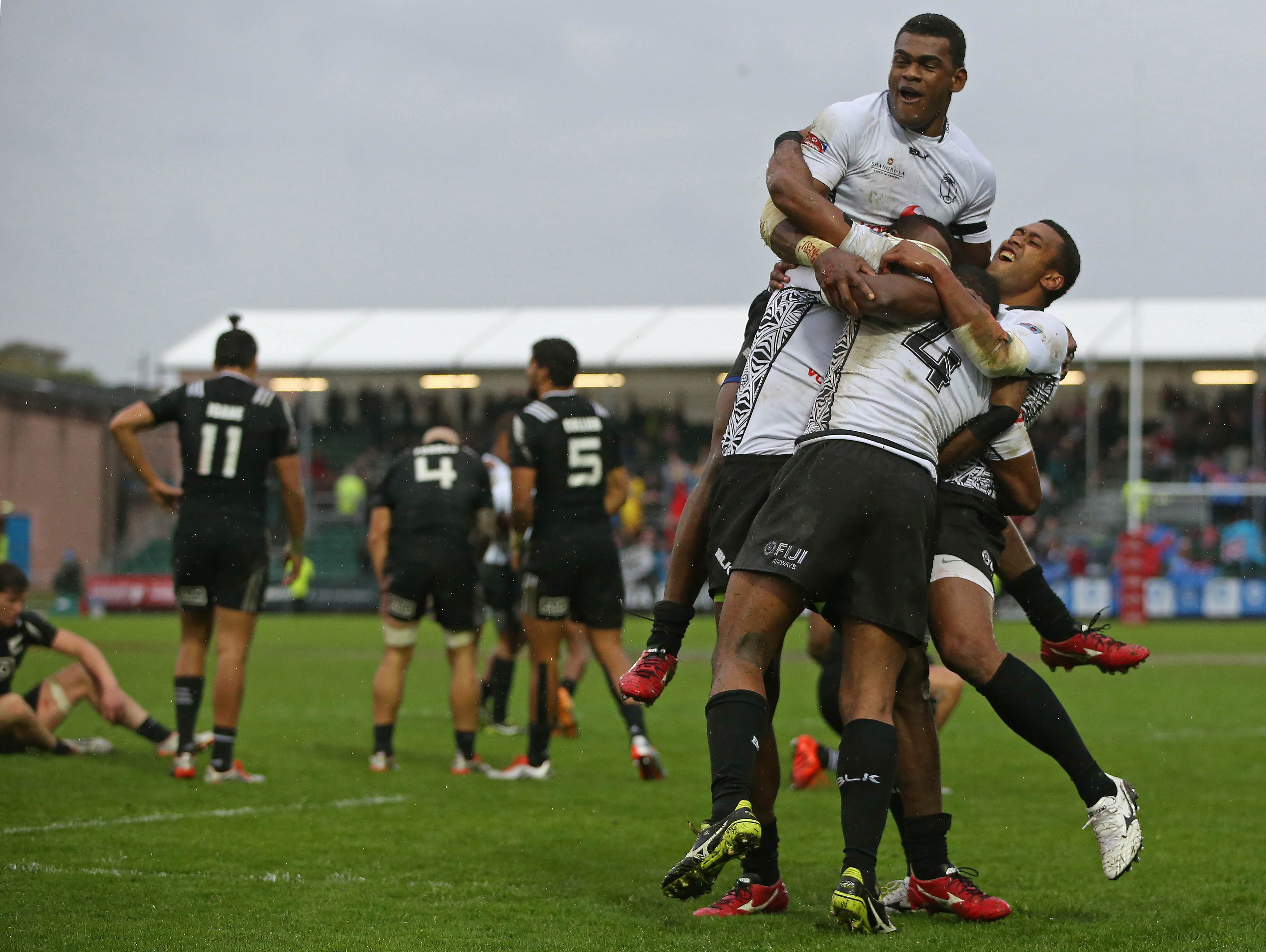 Fiji's players celebrate after beating New Zealand in the final at the Glasgow Sevens. Photos: AFP