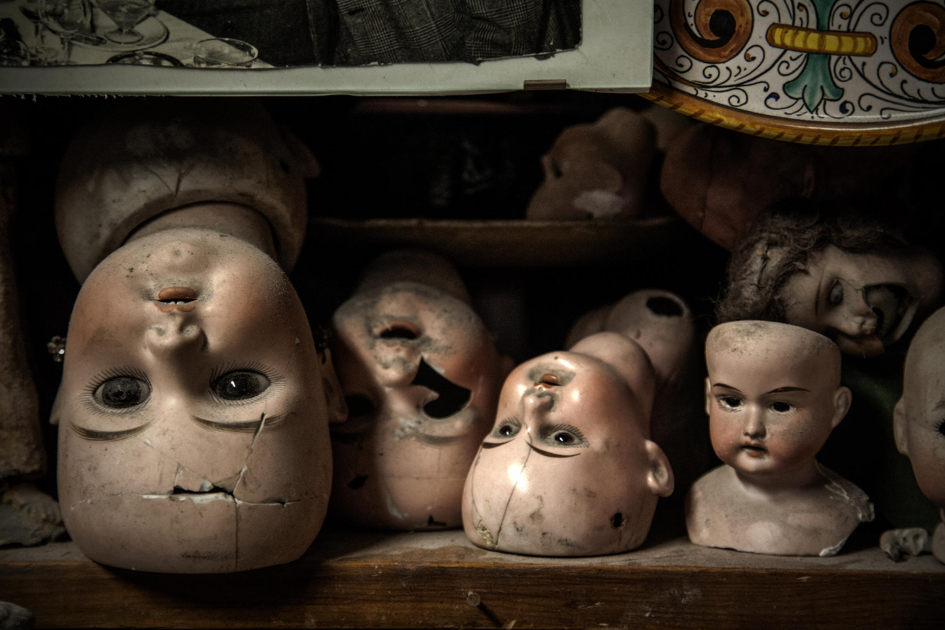 Broken heads of antique dolls line the hospital's shelves.