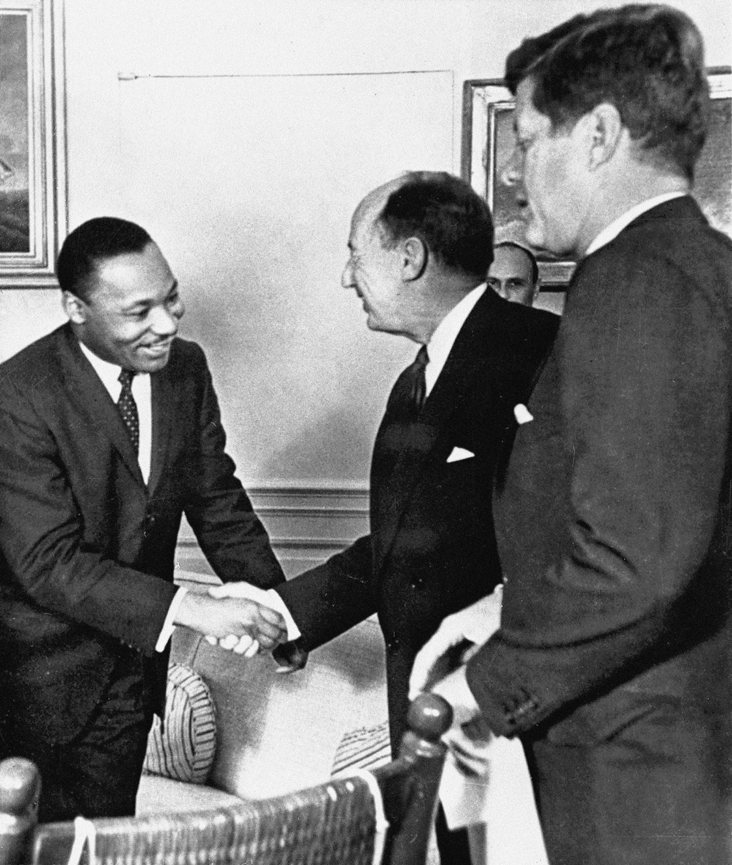 In this Dec. 17, 1962 file photo, Ambassador Adlai Stevenson, the U.S. delegate to the United Nations, shakes hands with Martin Luther King Jr., president of the Southern Christian Leadership Conference, Atlanta at the White House in Washington with President John F. Kennedy (right). Photo: AP