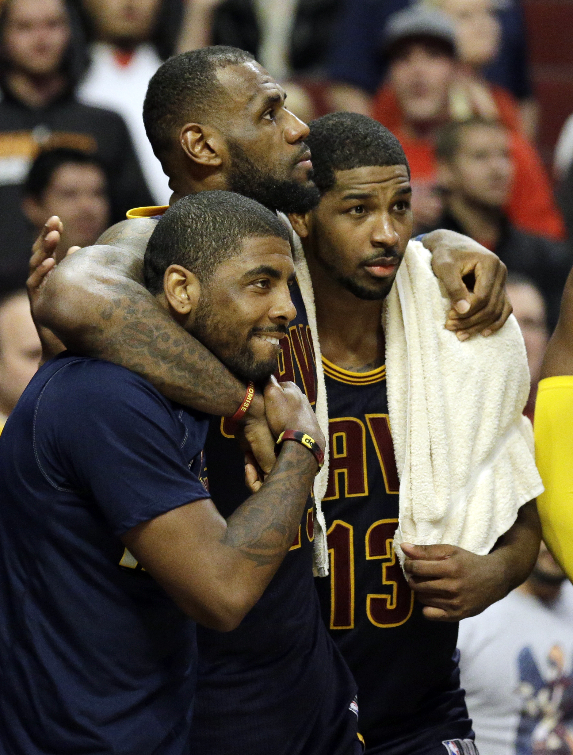 LeBron James watches the end of the game with guard Kyrie Irving, left, and centre Tristan Thompson. Photo: AP
