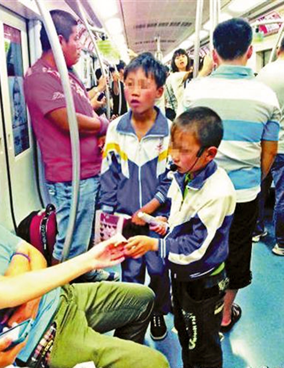 Children ask for money on a subway. Beijing is cracking down on panhandling inside the trains and stations. Photo: SCMP Pictures 