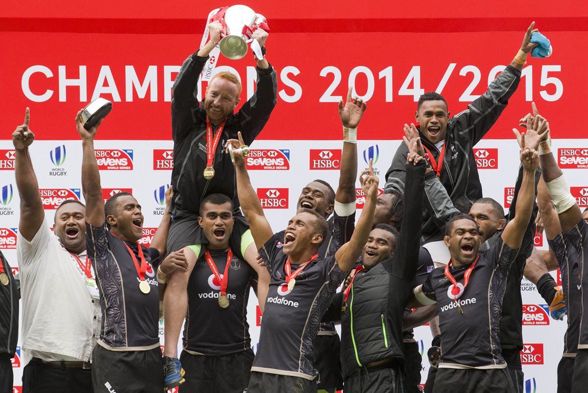 Ben Ryan hoists the silverware to finish the season on a high as Fiji celebrate being crowned 2014-15 Sevens World Series overall champions at the end of the London Sevens on Sunday. Photos: AFP