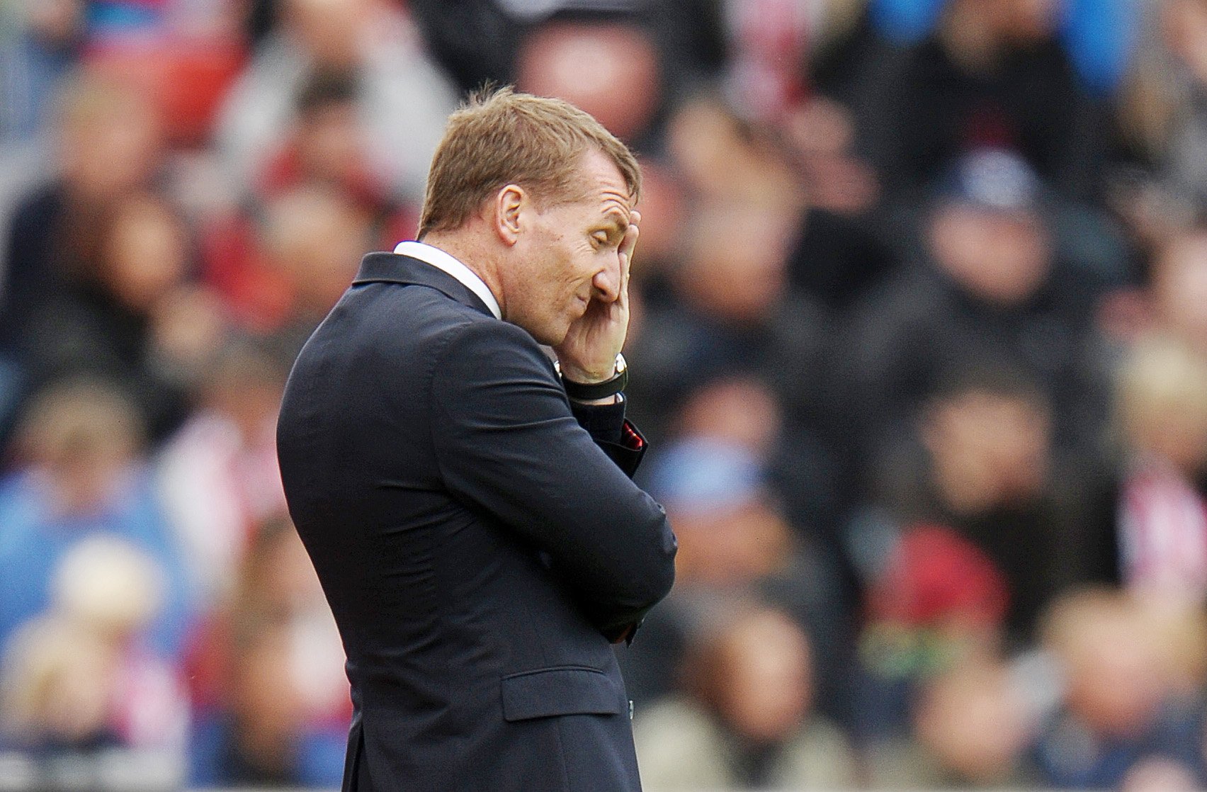 Liverpool manager Brendan Rogers can barely watch as his team capitulates 6-1 at Stoke. Photos: Reuters