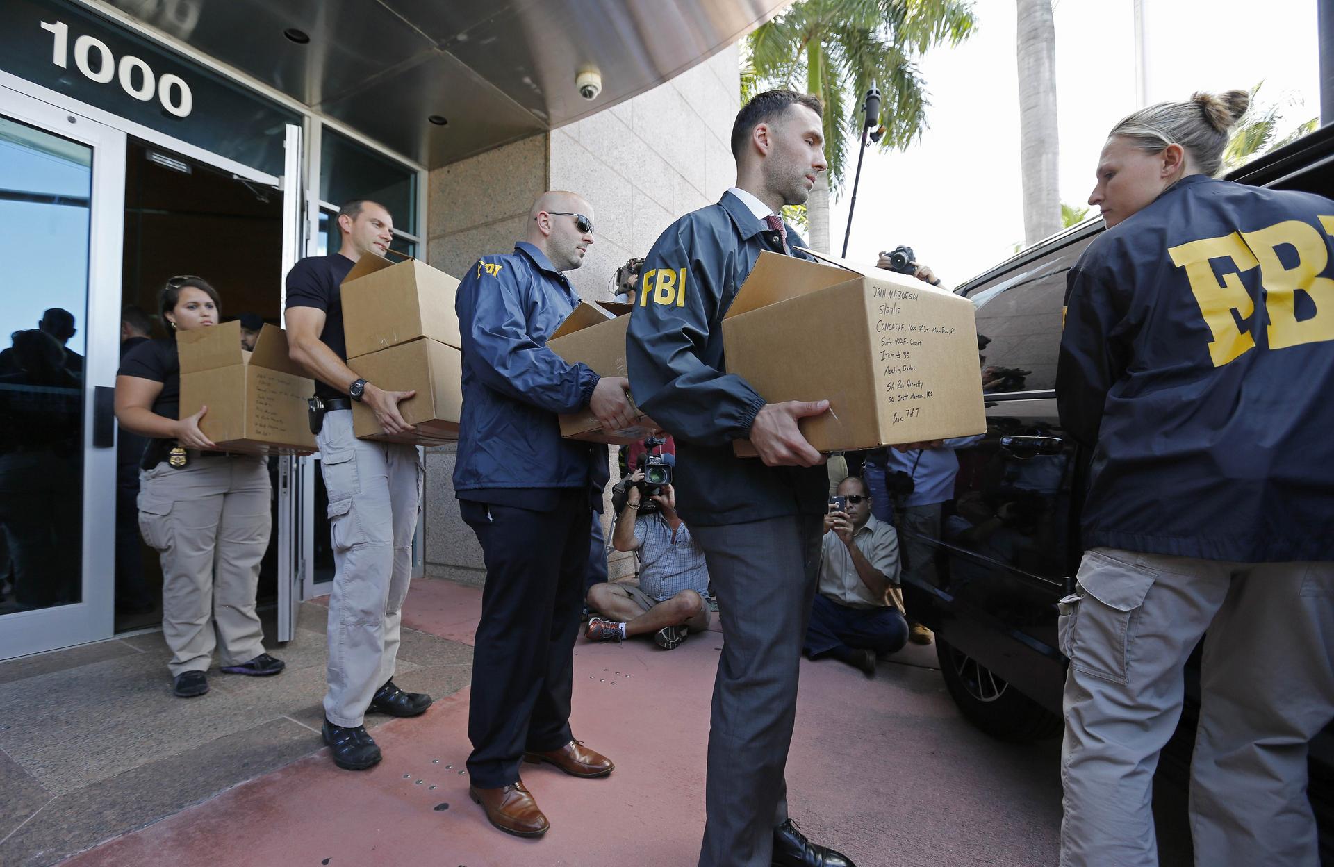 FBI agents after a raid on the headquarters of Concacaf. Photo: AFP