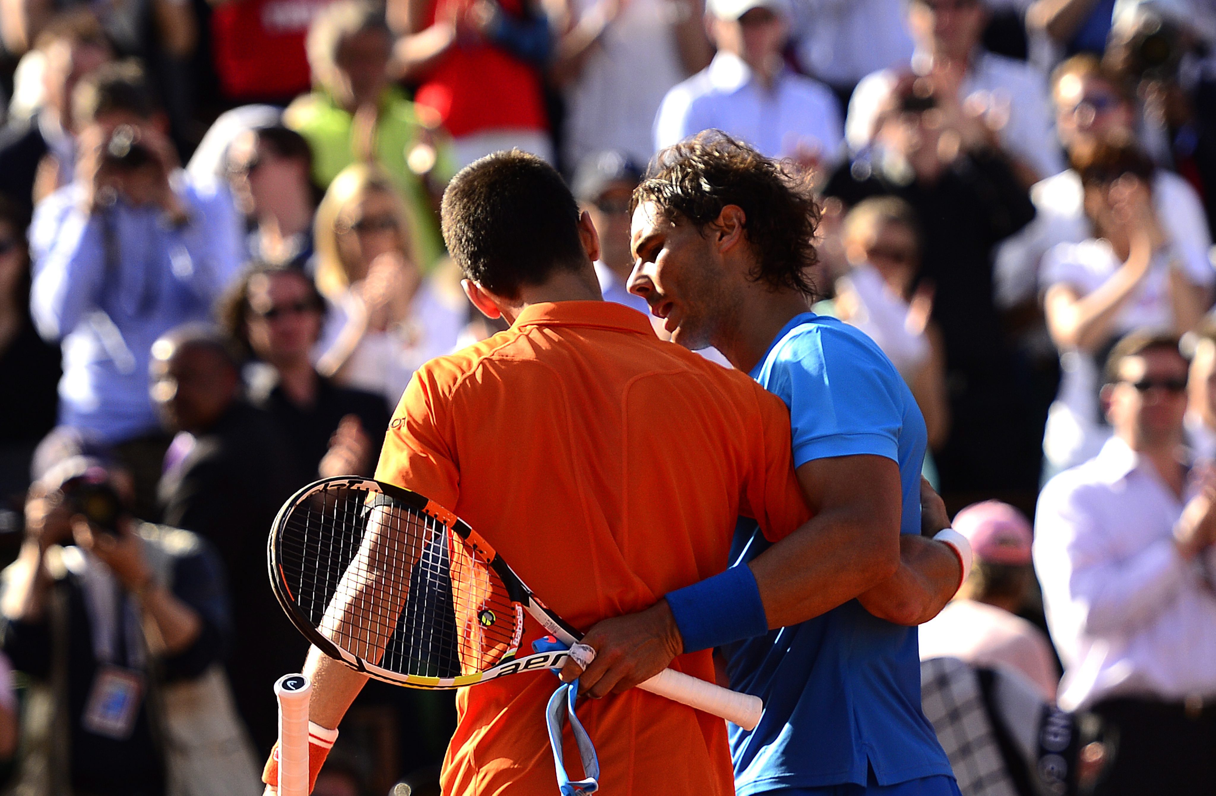 Novak Djokovic of Serbia hugs Rafael Nadal after beating the "King of Clay" in straight sets in their quarter-final match at Roland Garros.  Photo: EPA