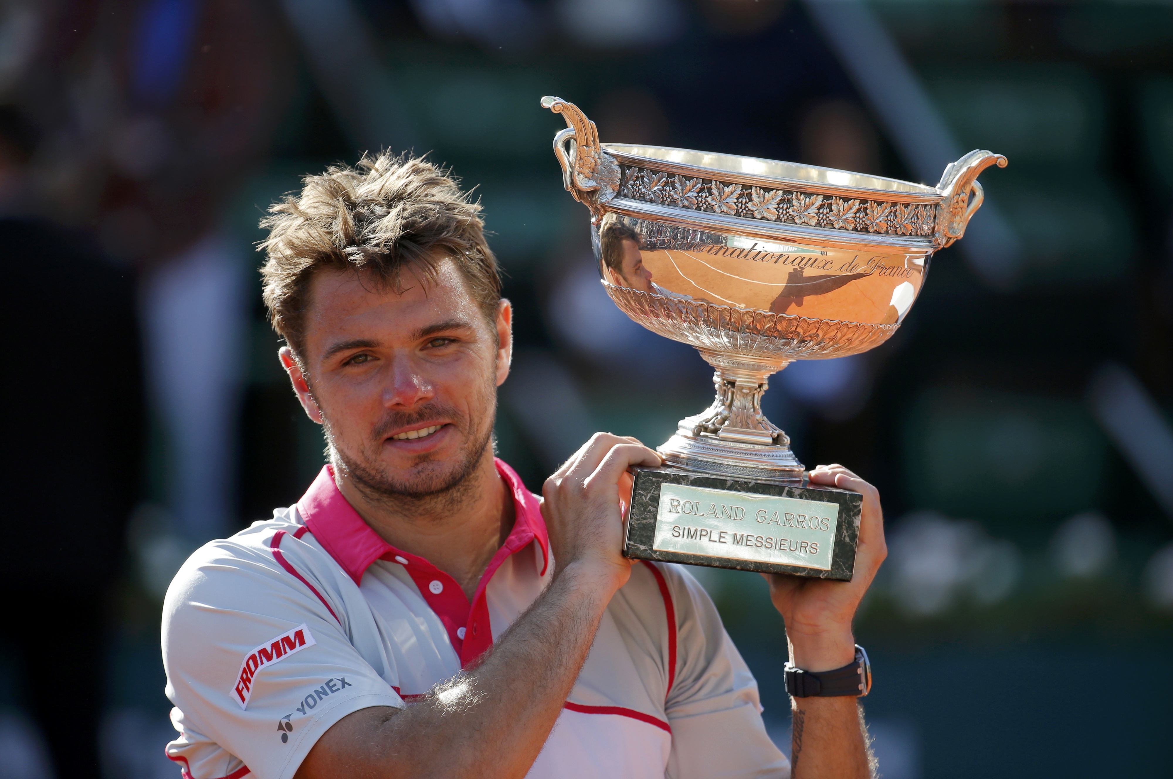 Stan Wawrinka of Switzerland poses with the trophy after winning the men's singles final against Novak Djokovic of Serbia. Photo: Reuters