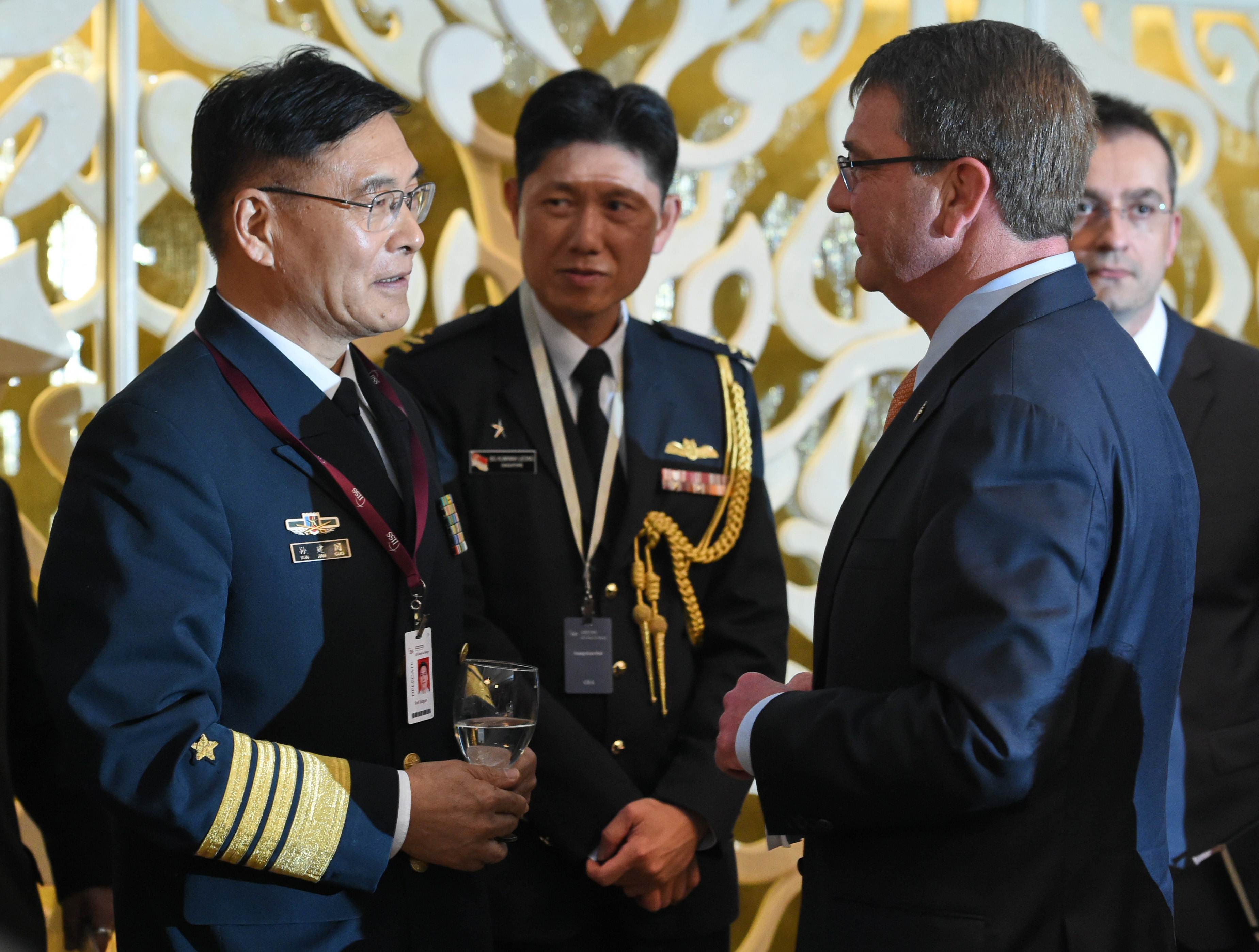 Admiral Sun Jianguo chats with US Secretary of Defence Ashton Carter during the ministerial luncheon at the  Shangri-La Dialogue in Singapore. Photo: AFP