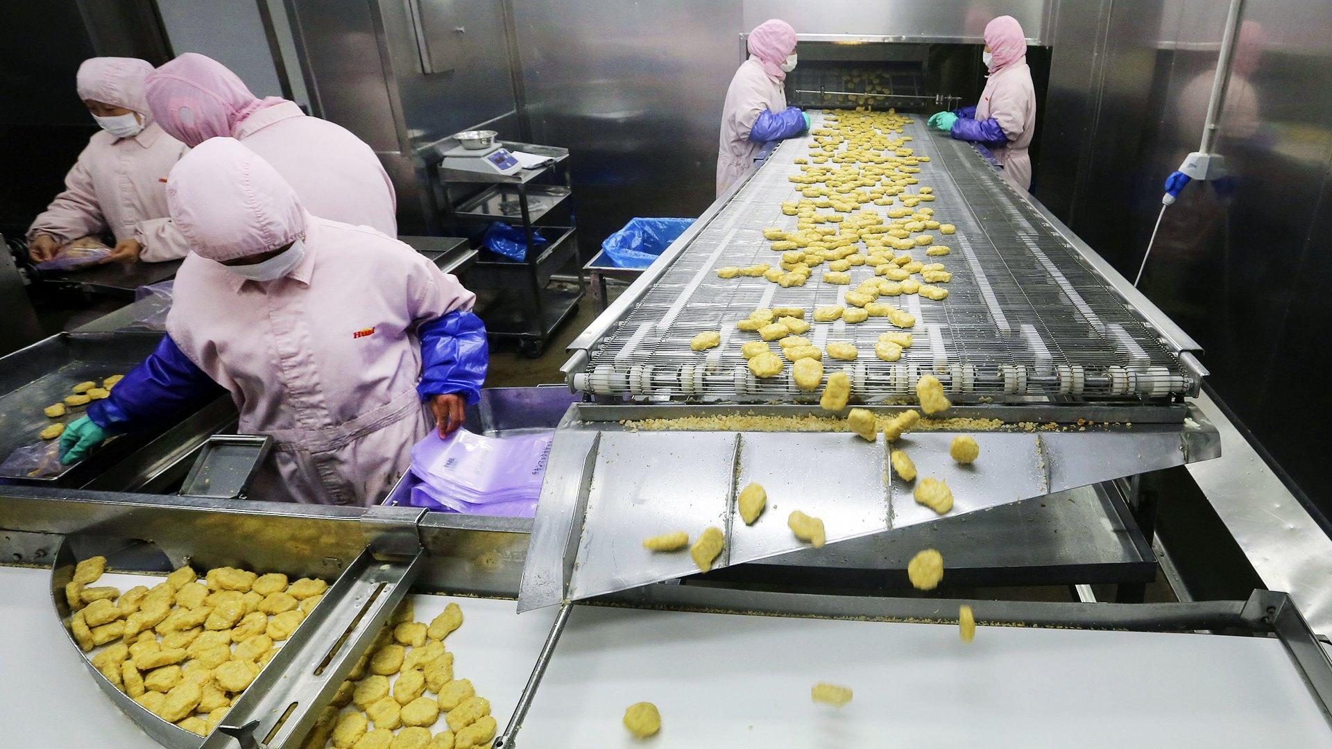 Employees work at a production line prior to inspections from the Shanghai Food and Drug Administration, at the Husi Food factory in Shanghai. Photo: Reuters