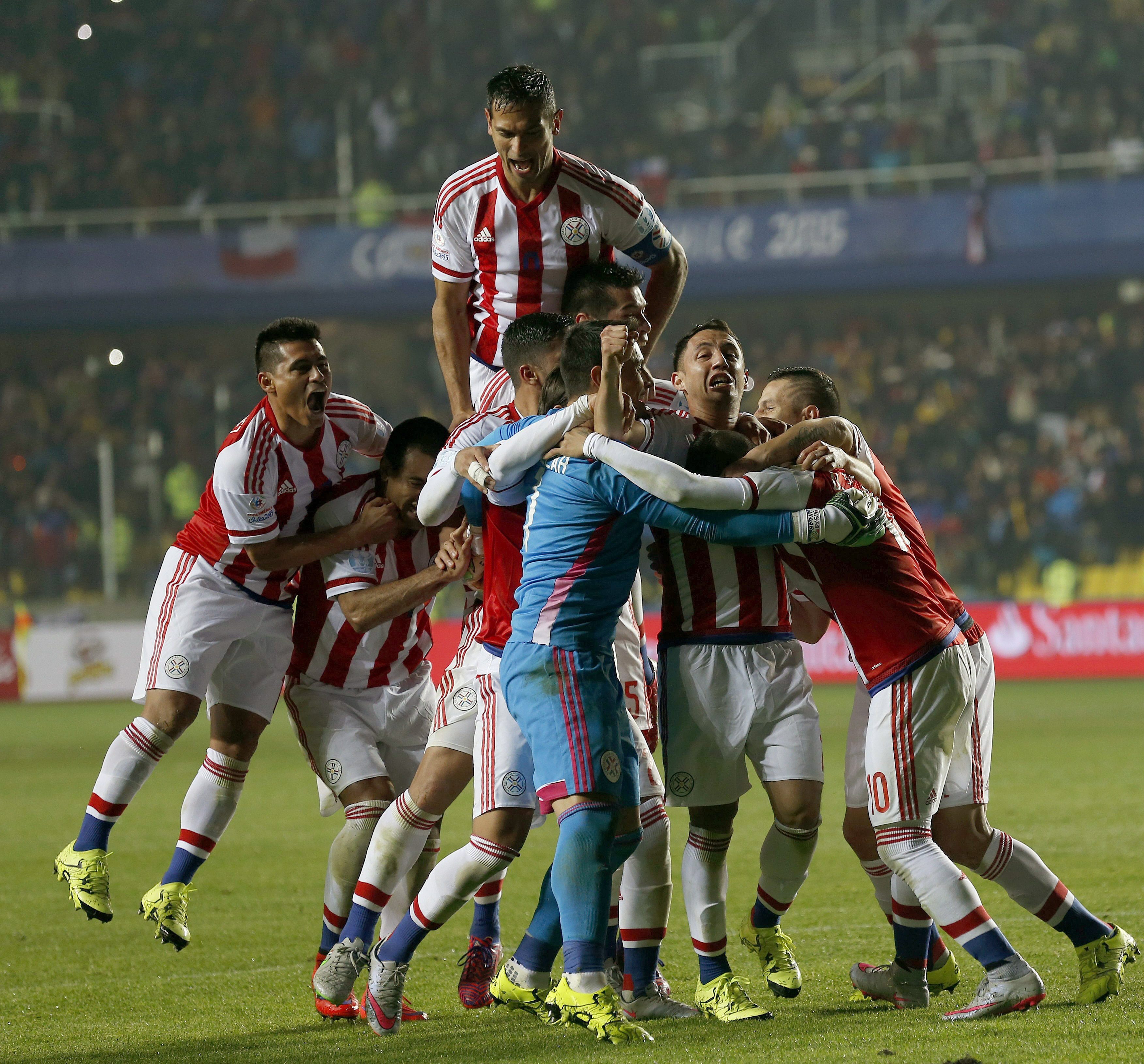 Paraguayan players celebrate teammate Derlis Gonzalez's goal in the penalty shootout. Photo: EPA
