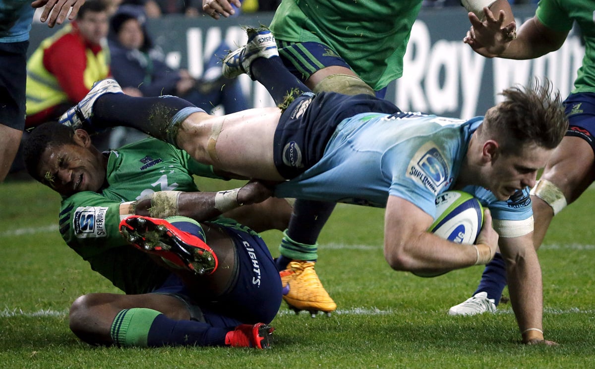 Bernard Foley of the New South Wales Waratahs is tackled by Highlanders winger Waisake Naholo during their Super Rugby semi-final match in Sydney on Saturday. The Highlanders beat the Tahs 35-17. Photo: Reuters
