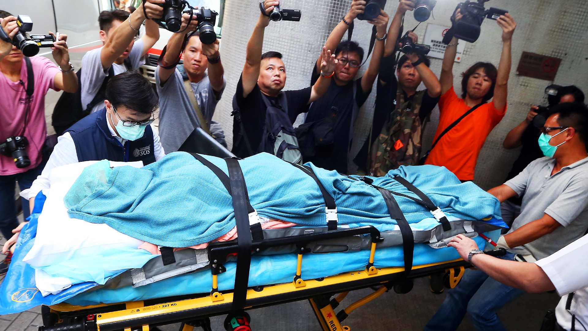 A woman who suffered burns in a dust explosion in Taiwan arrives at Queen Mary Hospital. Photo: Sam Tsang