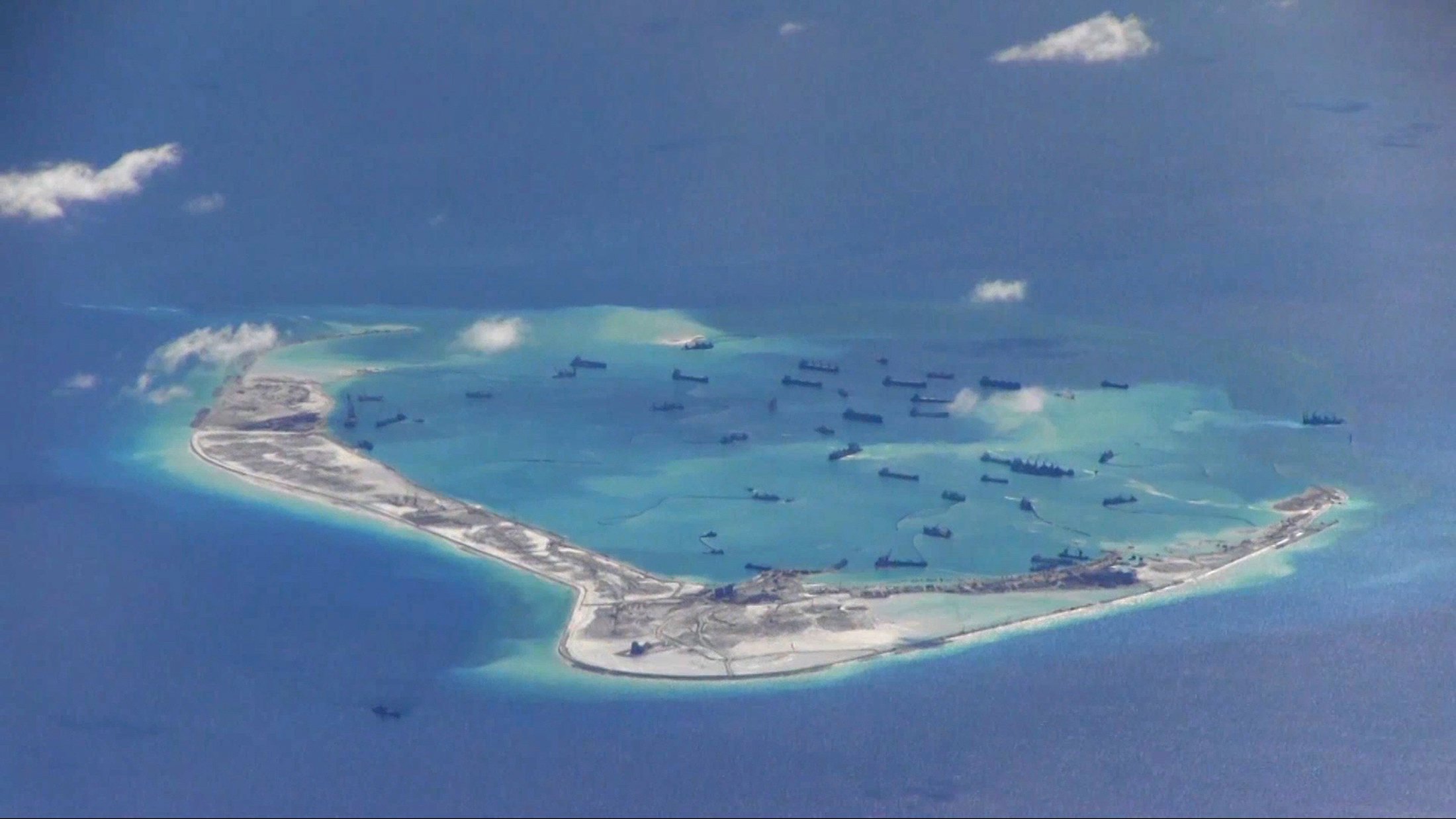 Chinese dredging vessels are seen in the waters around Mischief Reef in the disputed Spratly Islands in the South China Sea. Photo: Reuters