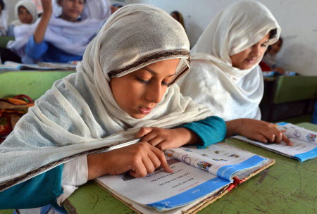These girls studying at a government school in Peshawar symbolise Pakistan's commitment to educational reform. Photo: AFP