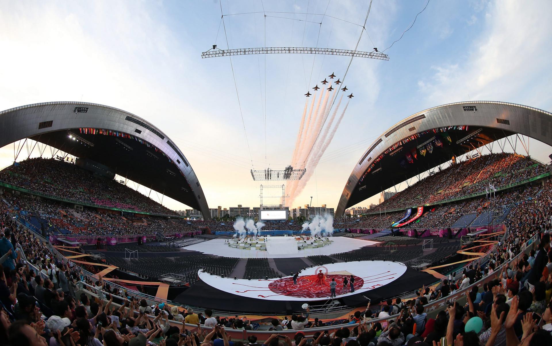 South Korea's military aerobatic team flies over the main stadium at the Universiade opening ceremony in Gwangju on Friday.Photo: EPA