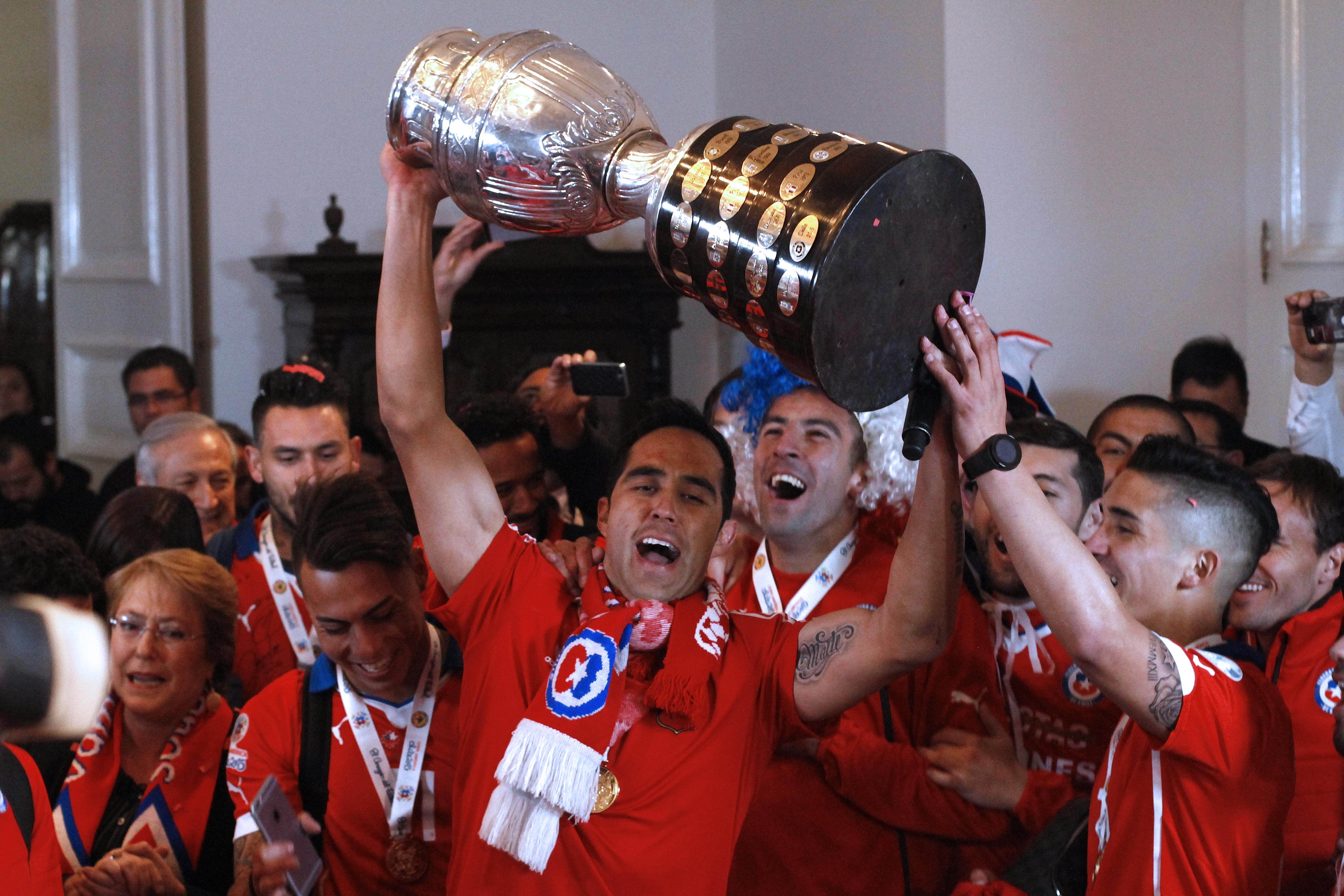 Chile players hold up the trophy at La Moneda presidential palace in Santiago. Photo: AFP