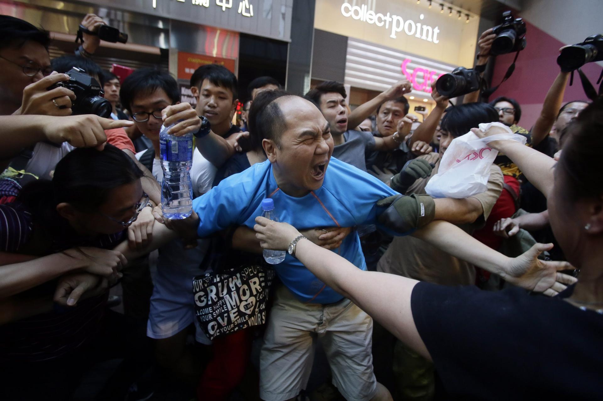 Political confrontations like this one during the Umbrella Movement in October have to stop. Photo: EPA
