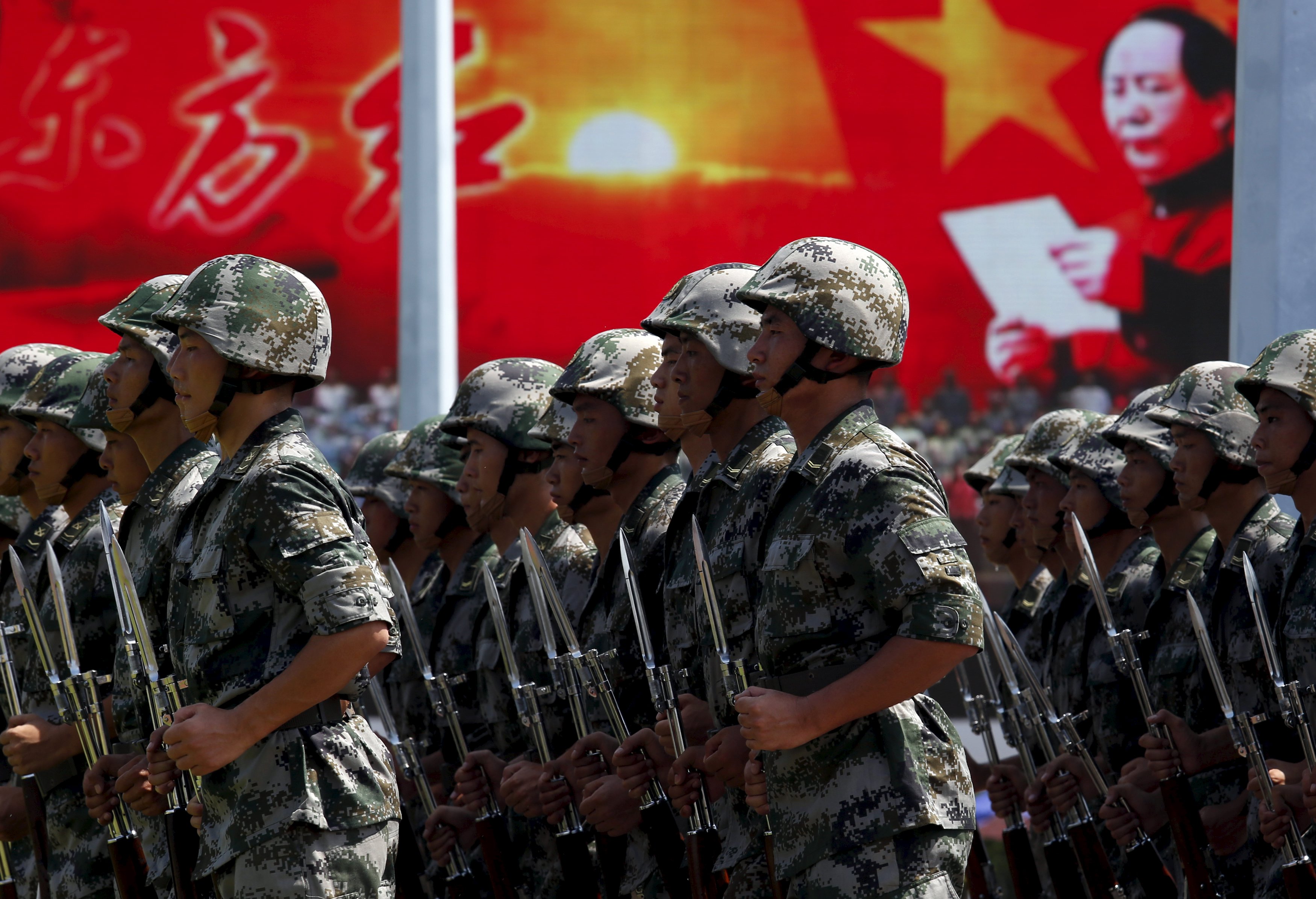 People's Liberation Army soldiers stationed in Hong Kong take part in a ceremony to mark the 18th anniversary of the handover on July 1. Photo: Reuters