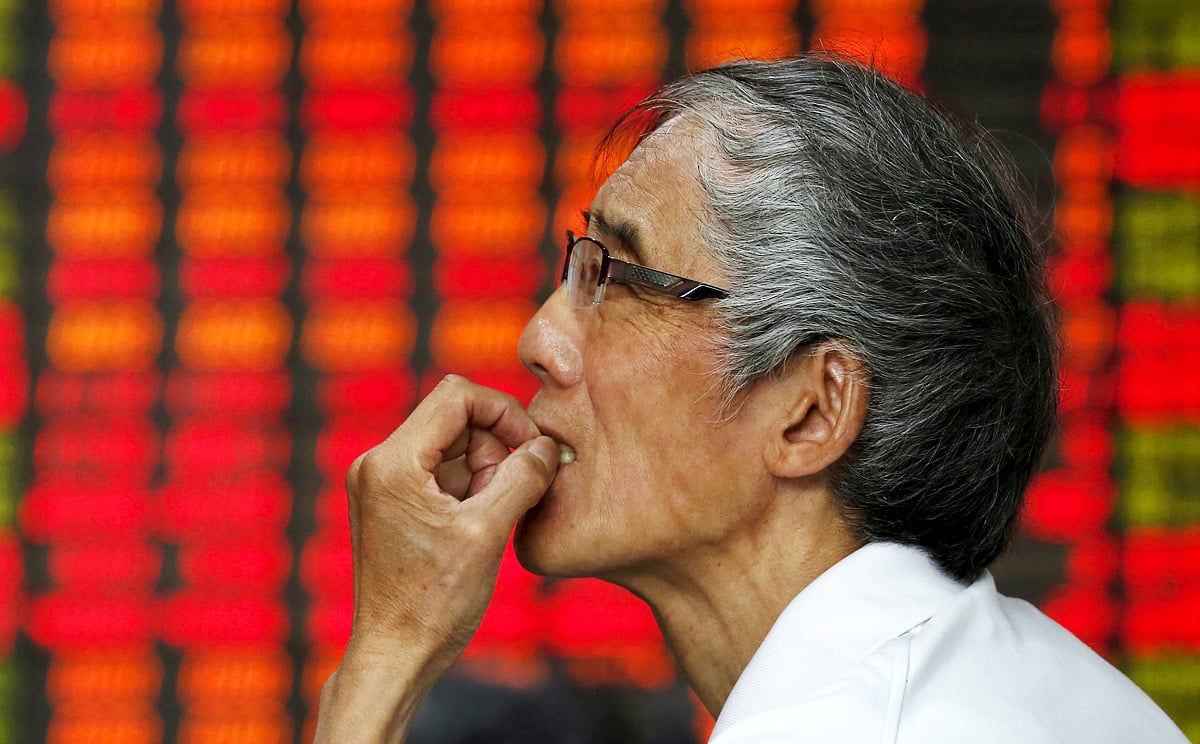 A stock investor checks prices in a brokerage house in Fuyang in central China's Anhui province. Photo: Reuters