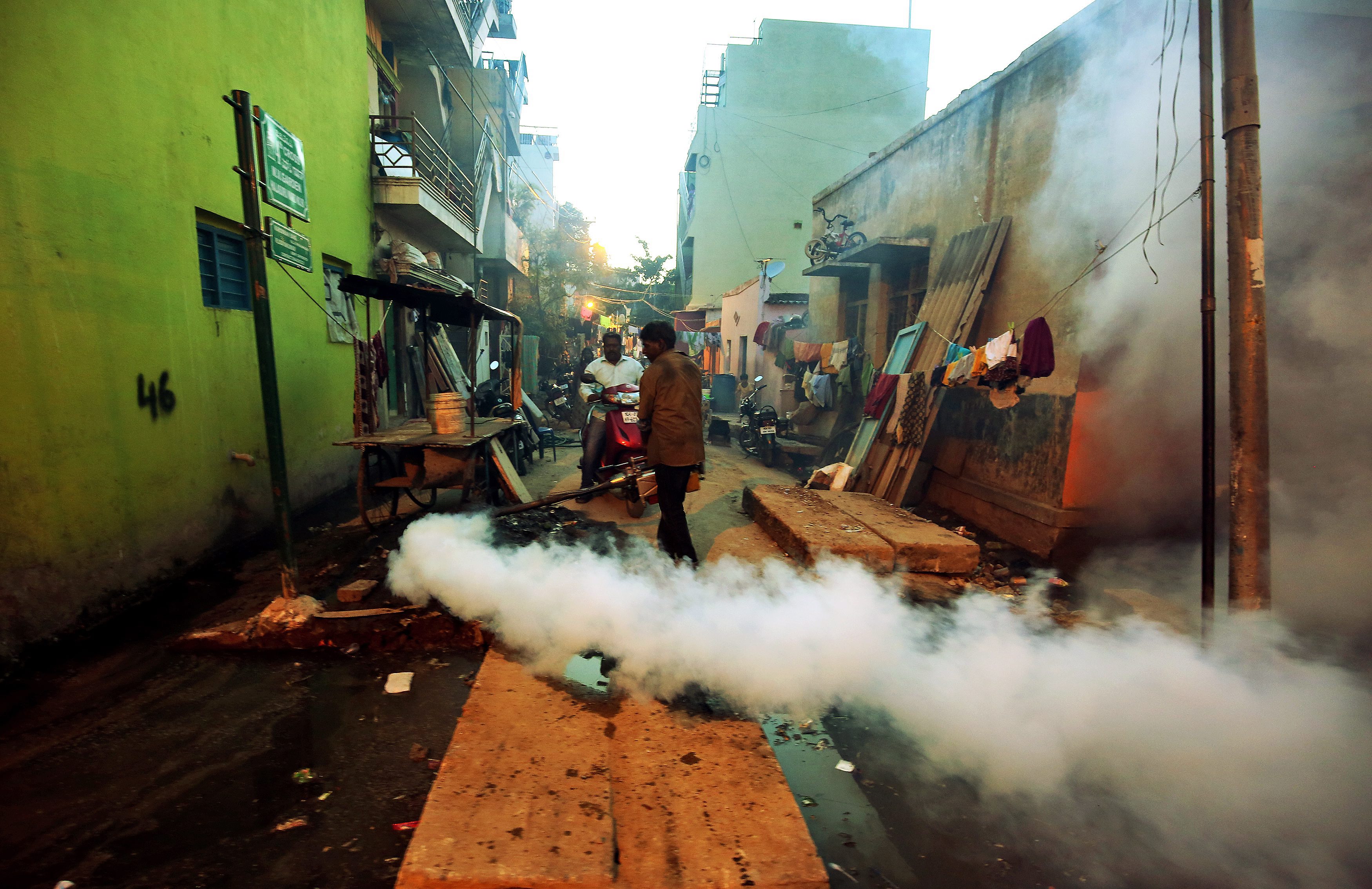 A civic administration worker carries out fumigation to curb mosquito growth in Bangalore, India. Improving access to basic services is on the agenda. Photo: EPA