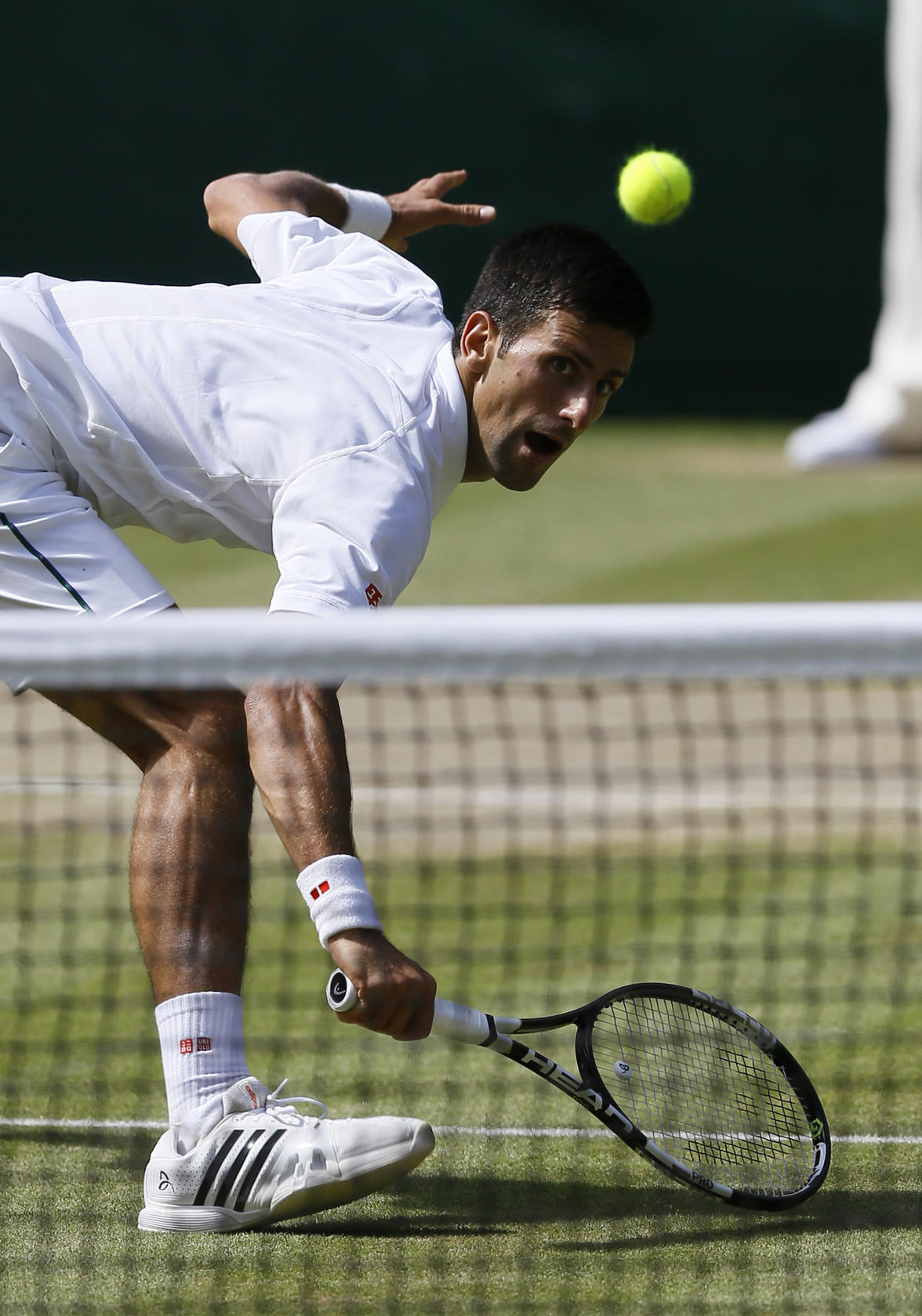 Novak Djokovic makes a return to Richard Gasquet in their singles semi-final match yesterday. Photo: AP
