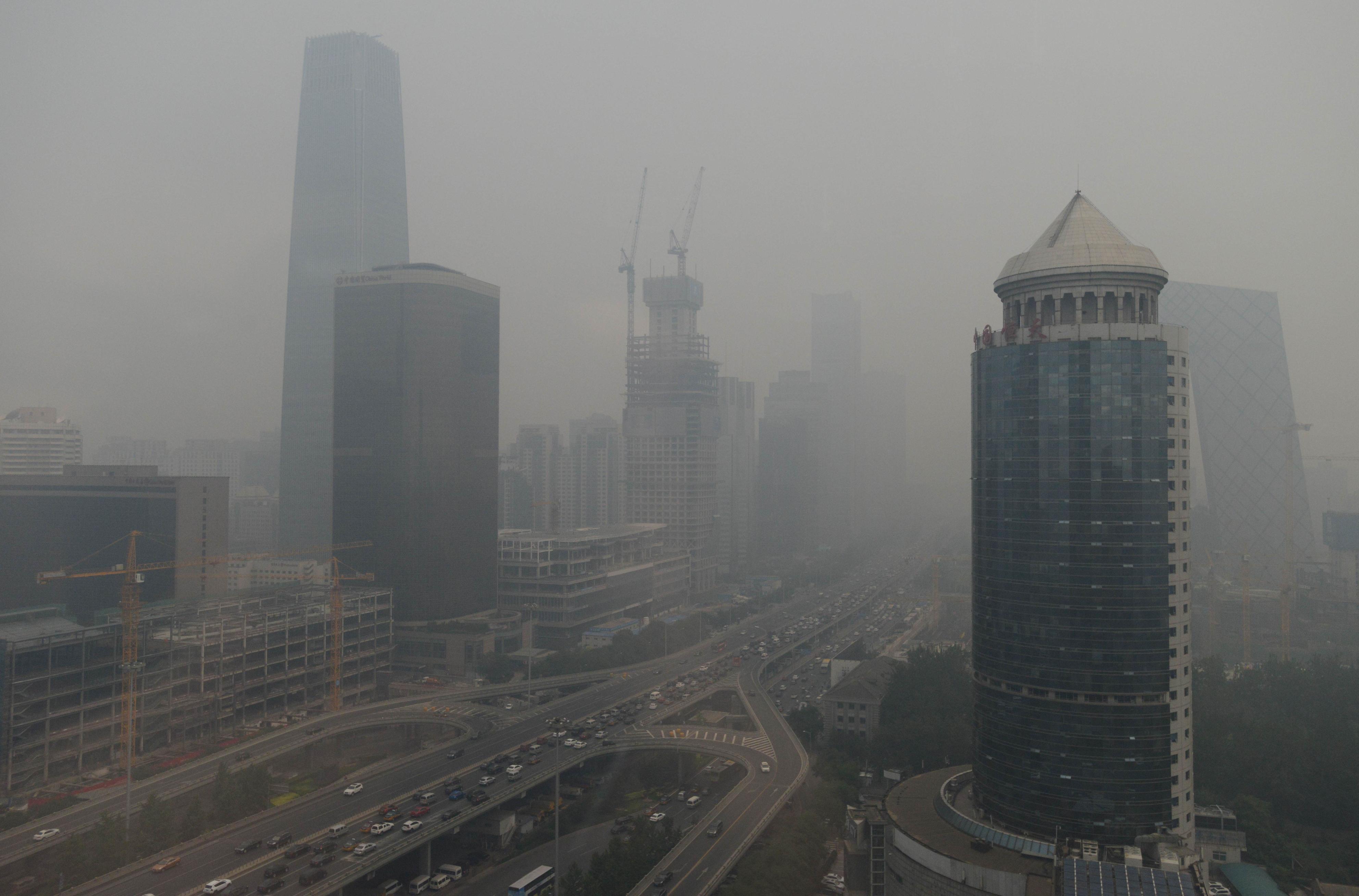 A choking smog envelops Beijing as bond markets could help China's pledge on climate change. Photo: Kyodo