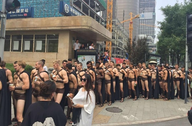 Foreign male models dressed in Spartan-like costumes walked through Beijing streets in a local store's PR stunt. 
